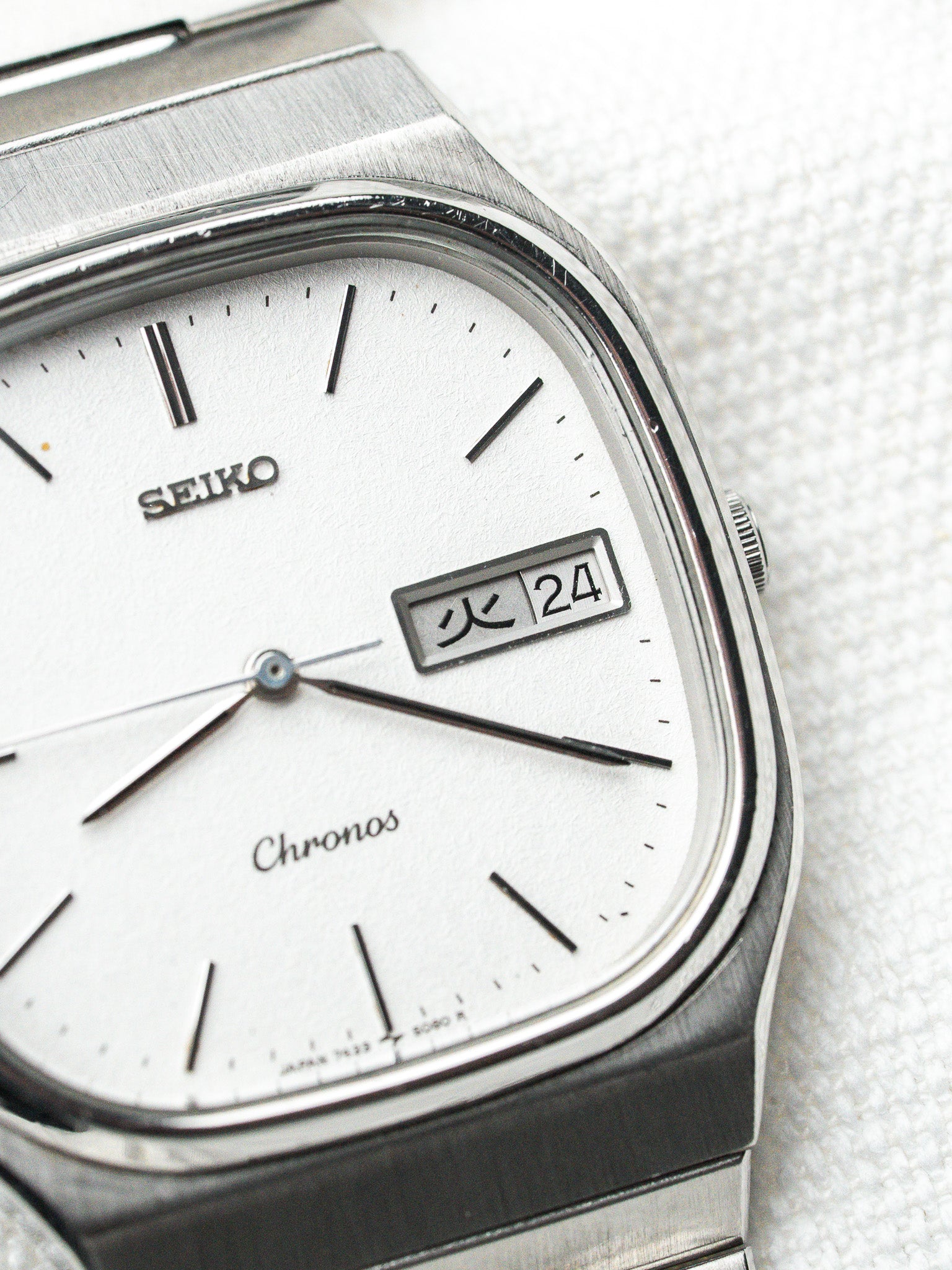Seiko Chronos vintage watch with silver dial, day-date window, and brushed steel case