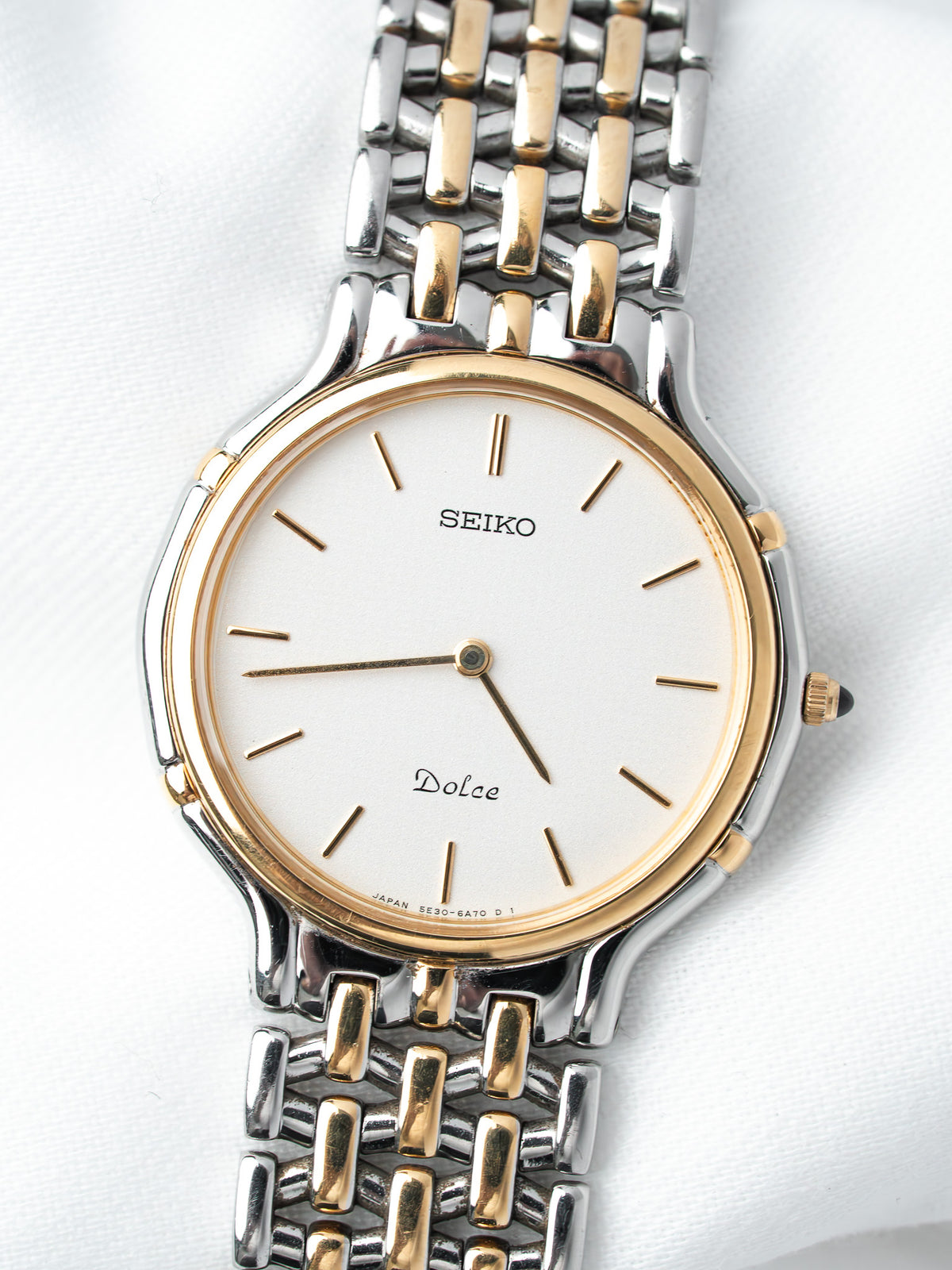 Seiko Dolce vintage watch with white dial, gold accents, and two-tone bracelet on white background