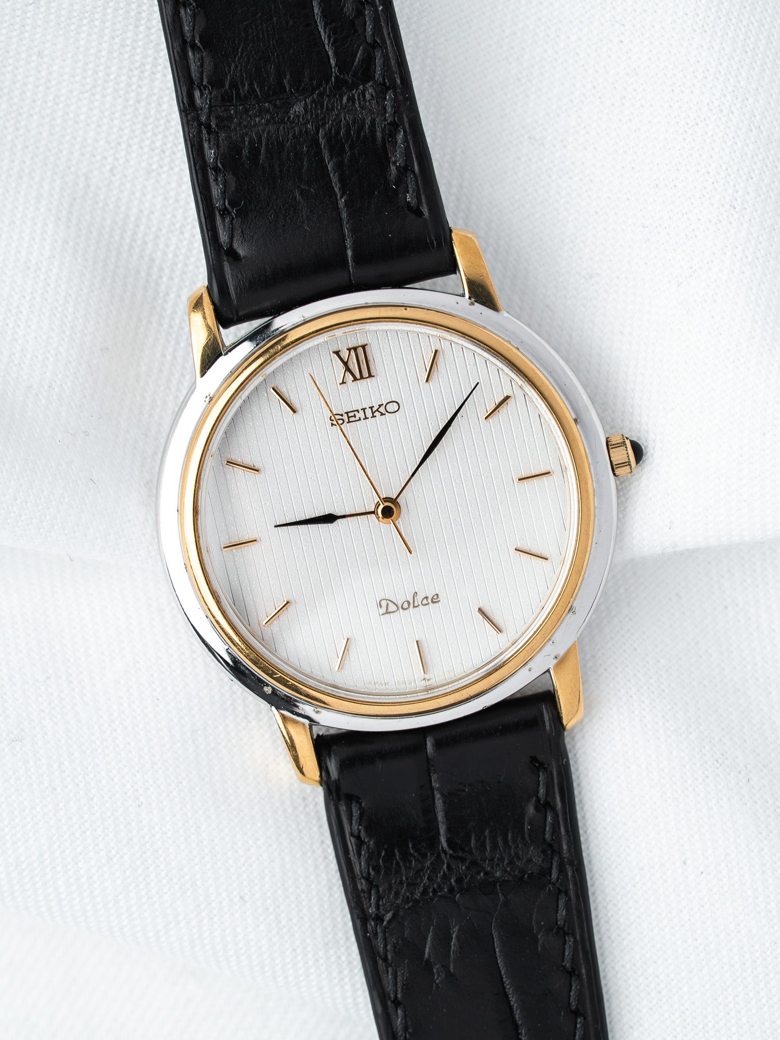 Seiko Dolce vintage watch with white dial, gold accents, black leather strap