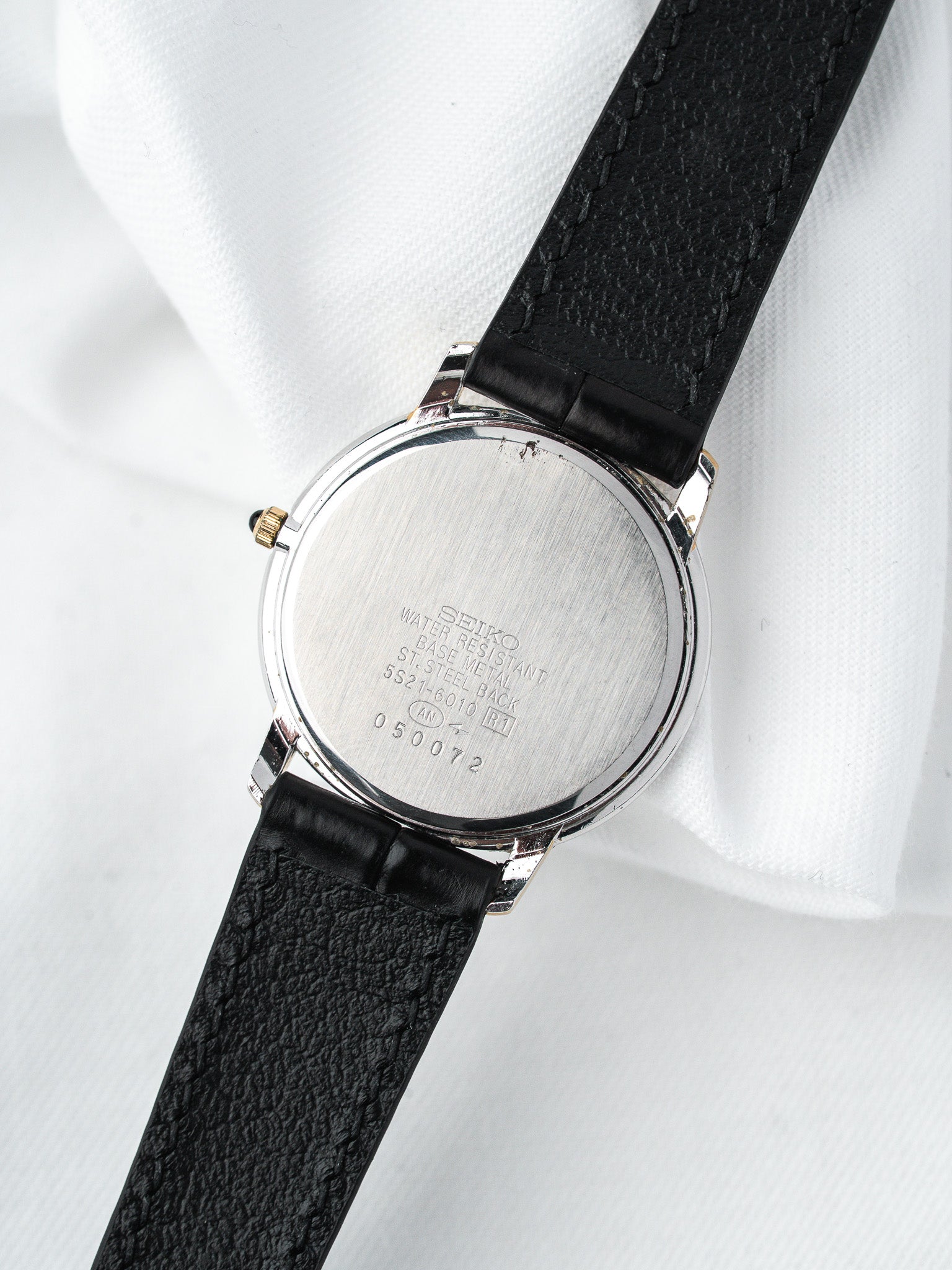 Seiko vintage watch with stainless steel case back and black leather strap