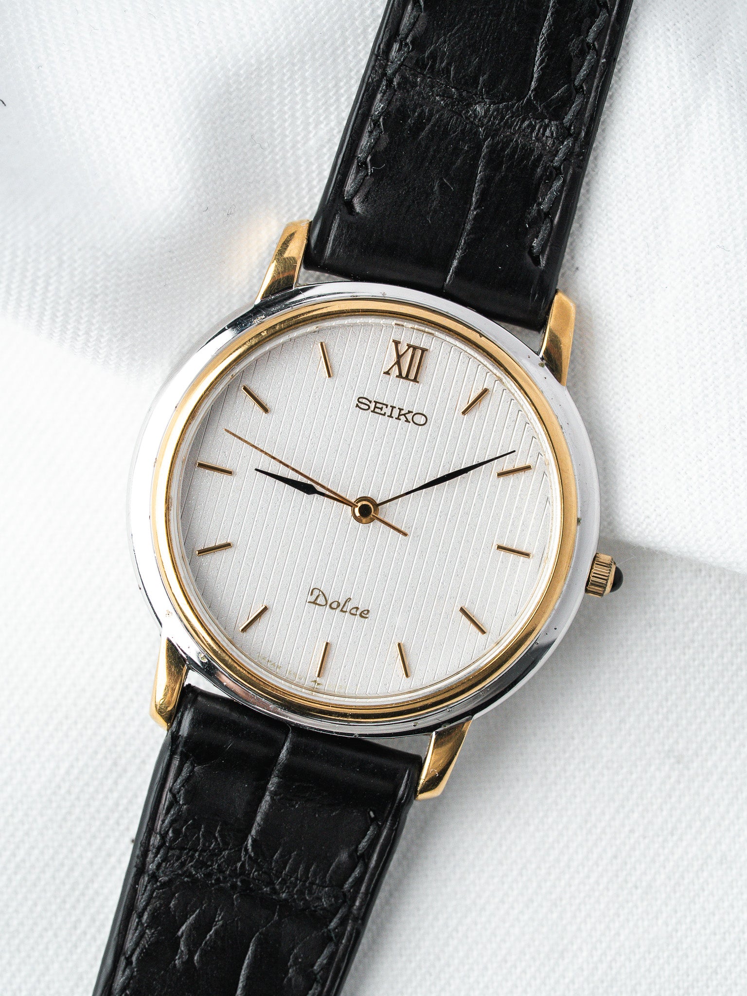Seiko Dolce vintage watch with white dial, gold accents, black leather strap