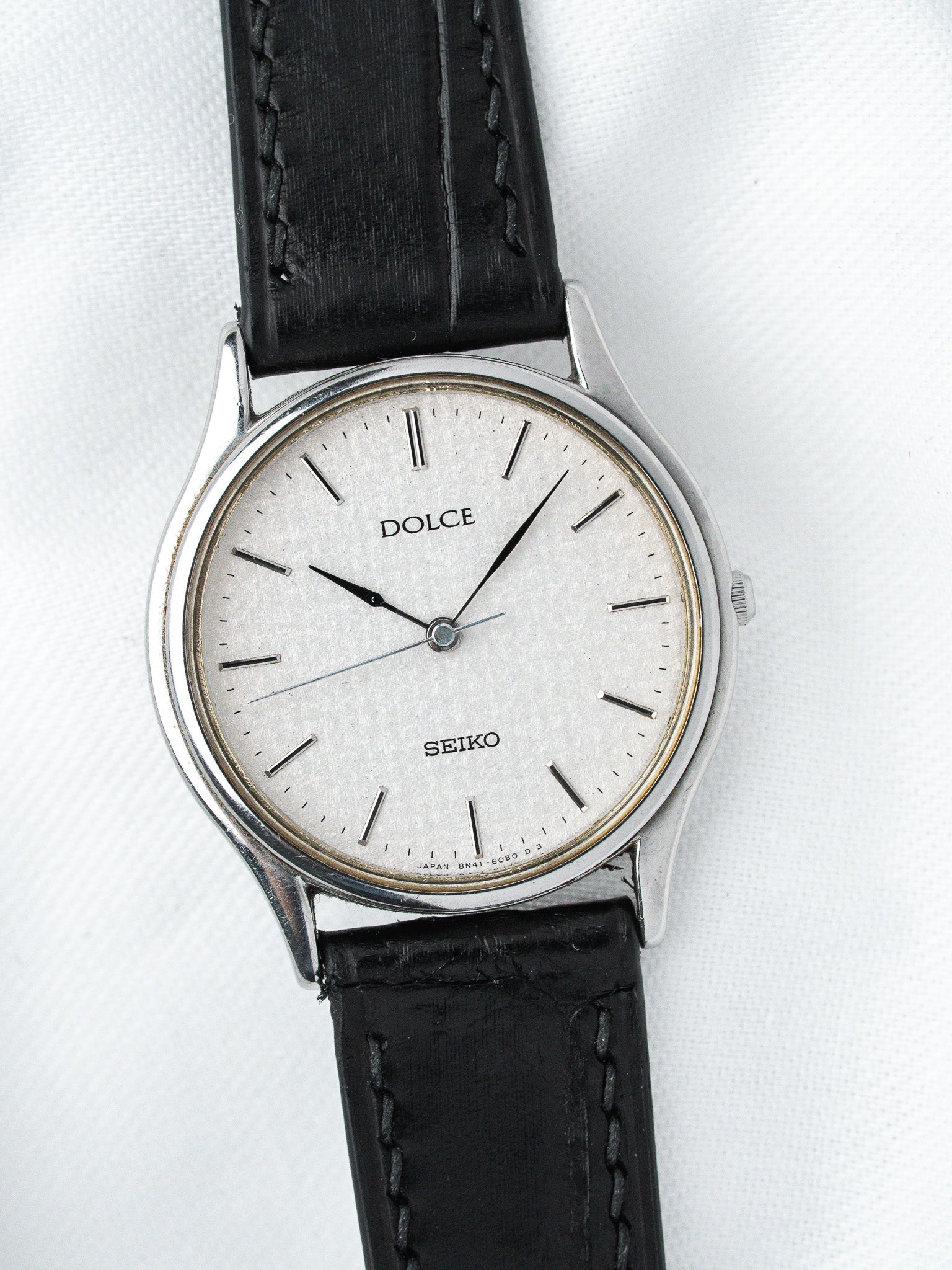 Seiko Dolce vintage watch with silver dial, black leather strap, and steel case
