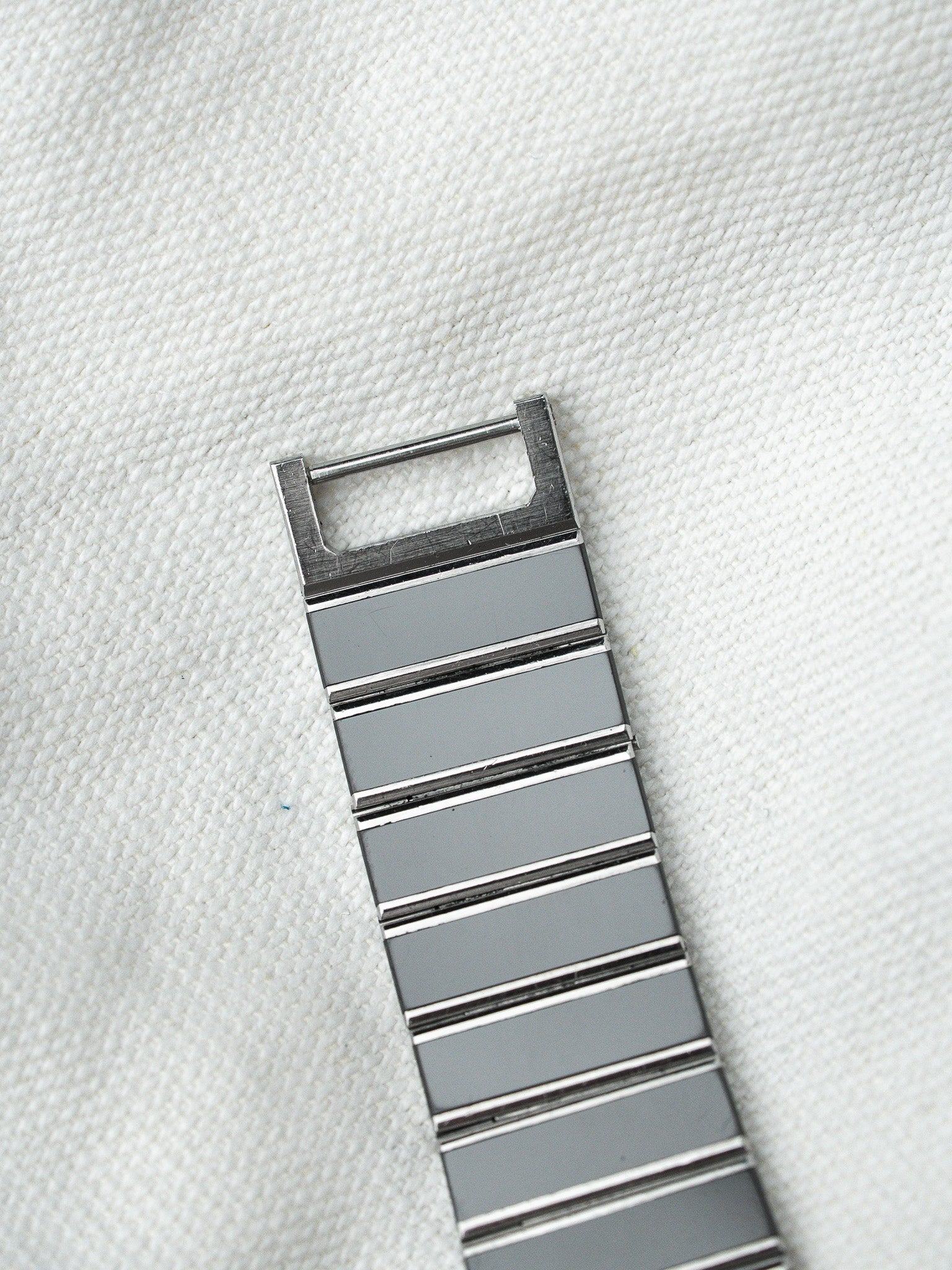 Vintage Omega Seamaster bracelet in stainless steel with polished links on white fabric