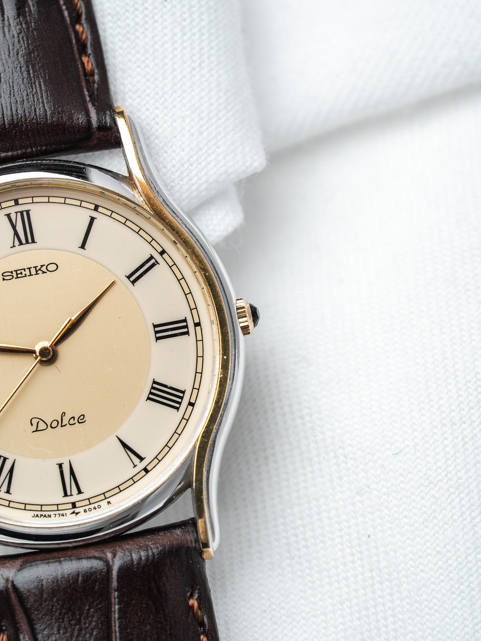 Seiko Dolce vintage watch with cream dial, Roman numerals, gold accents, brown leather strap