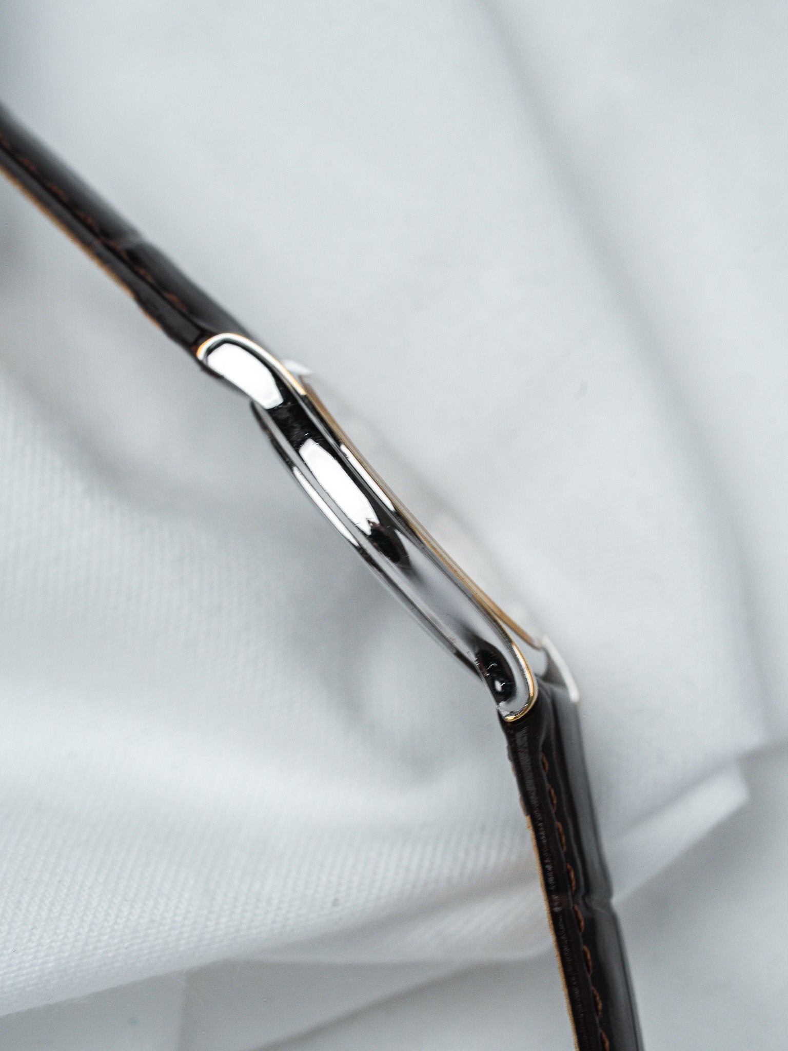 Vintage Cartier Tank watch with polished steel case and brown leather strap