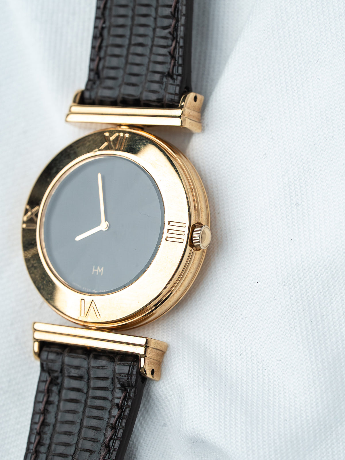 Vintage HM watch with gold case, gray dial, and black alligator strap