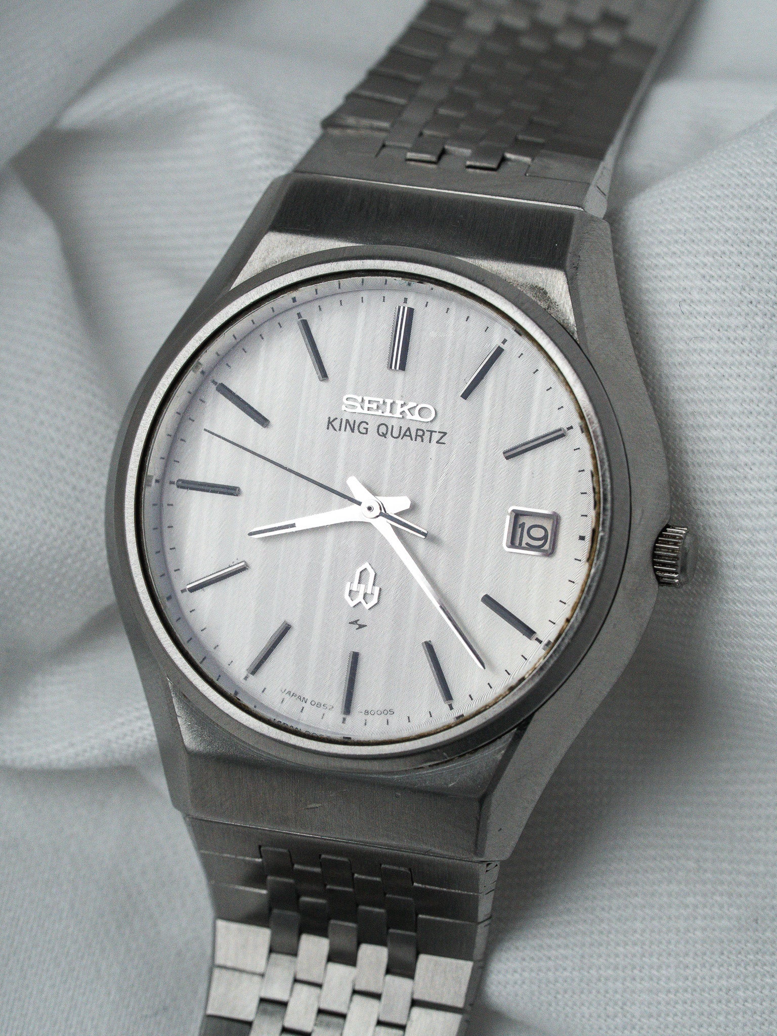 Seiko King Quartz vintage watch with silver dial and metal bracelet on fabric