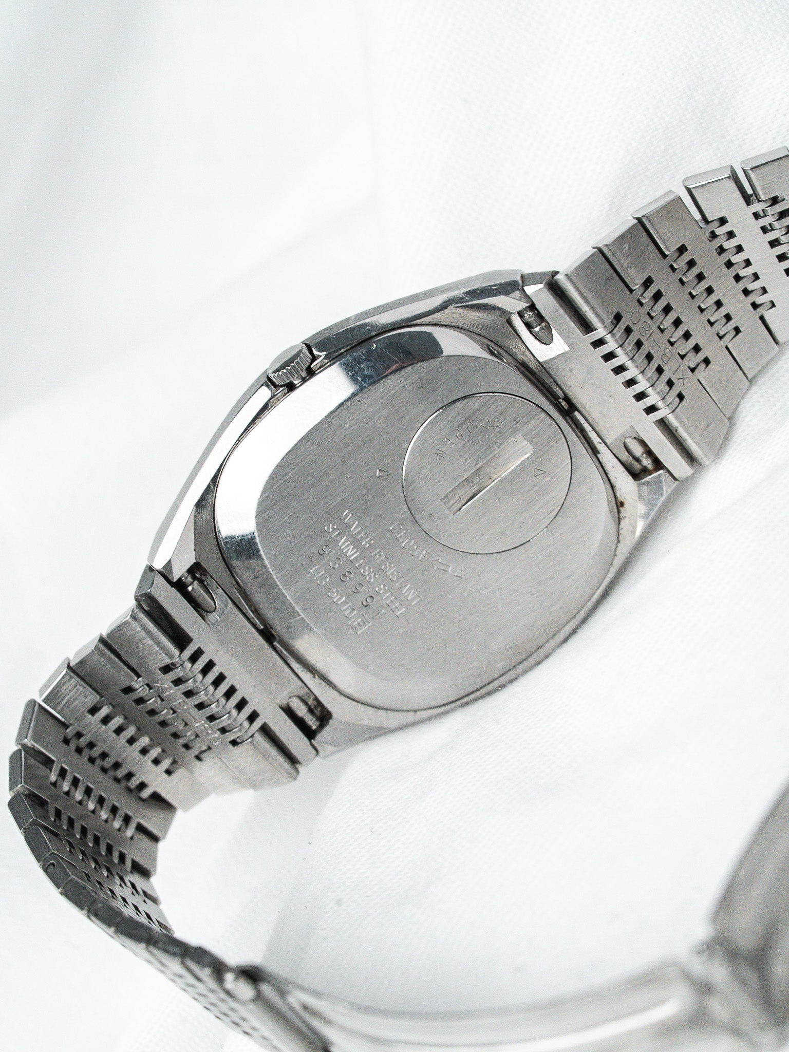 Omega vintage watch back stainless steel case with engraved details and mesh bracelet