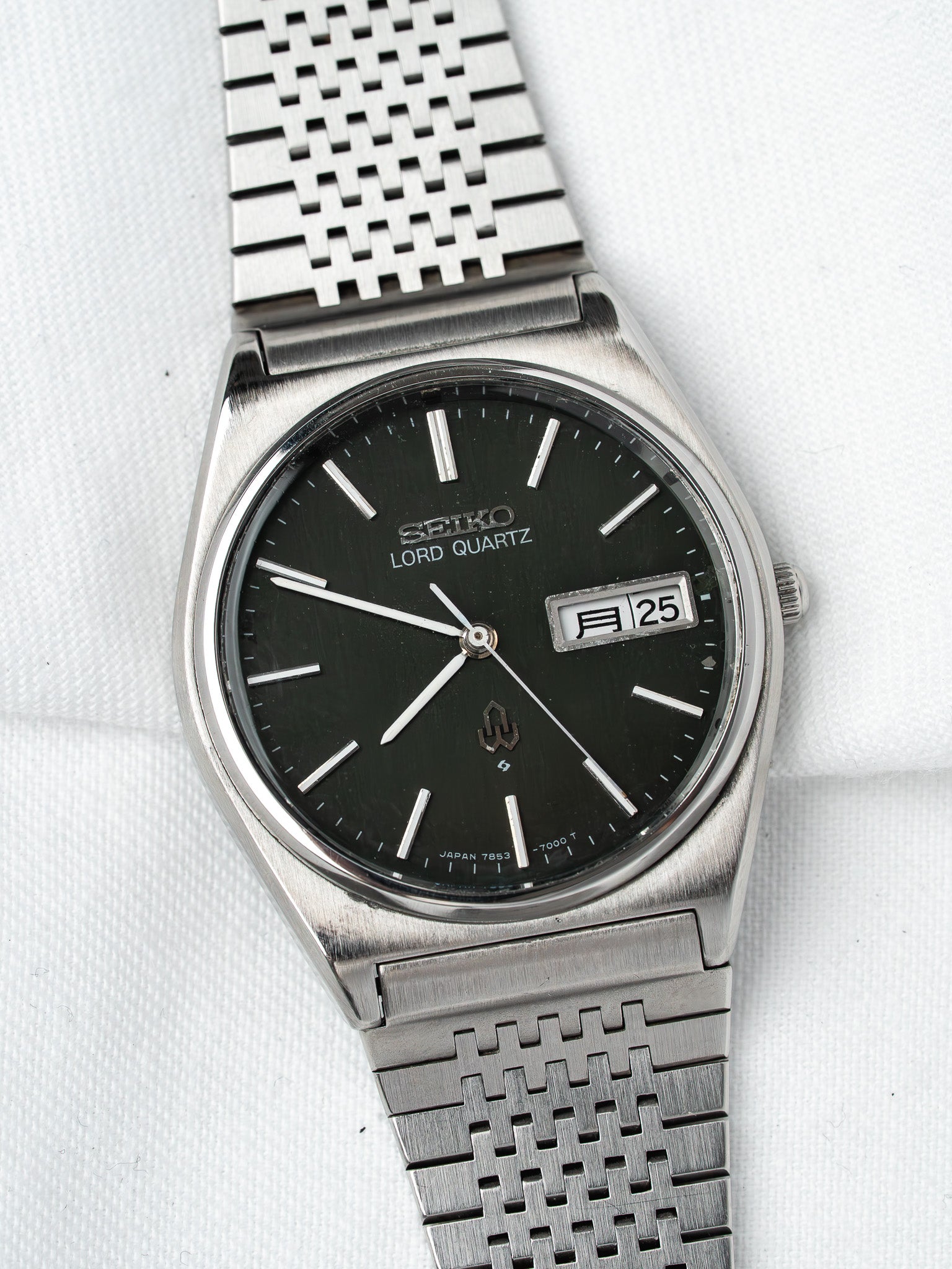 Seiko Lord Quartz vintage watch with black dial, date window, and steel mesh bracelet