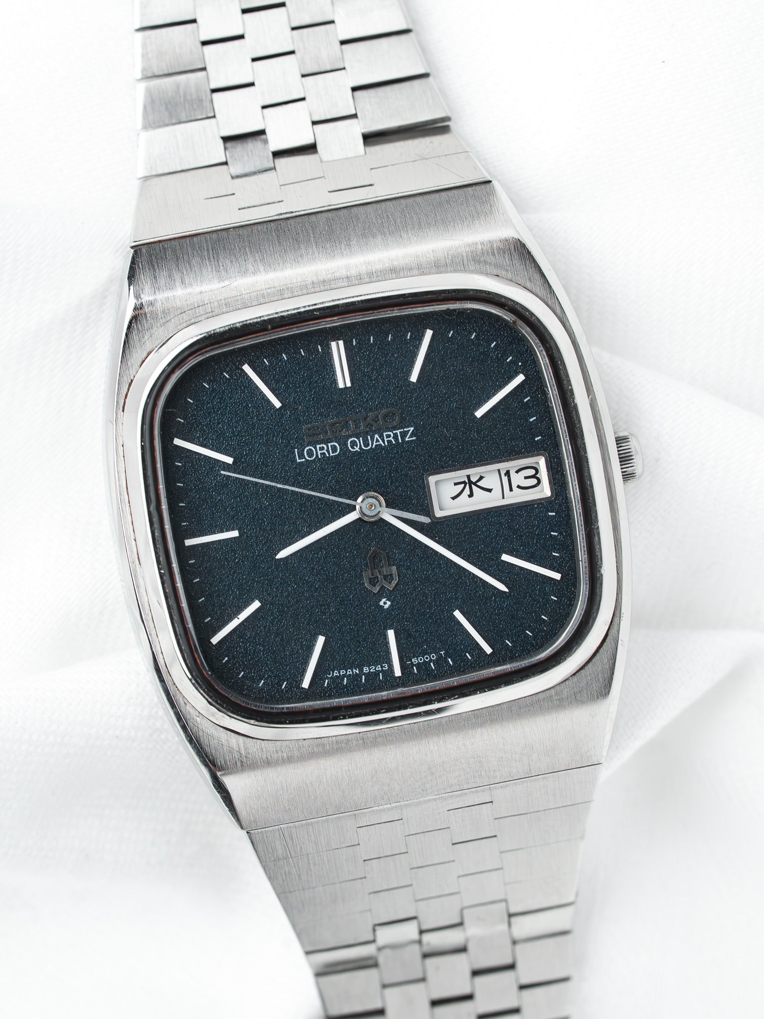 Seiko Lord Quartz vintage watch with black dial, steel bracelet, day-date display