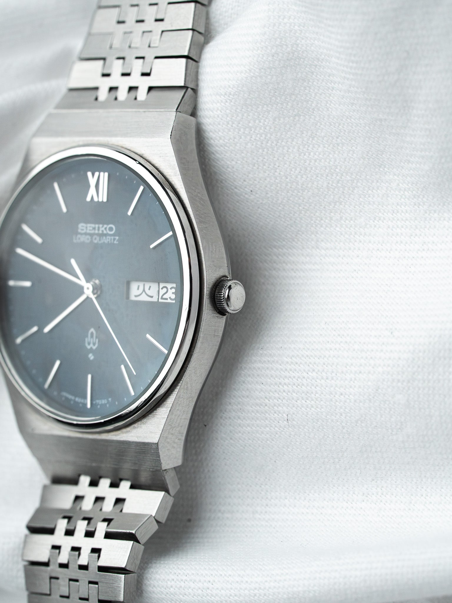 Seiko Lord Quartz vintage watch with grey dial, steel case and bracelet on white fabric