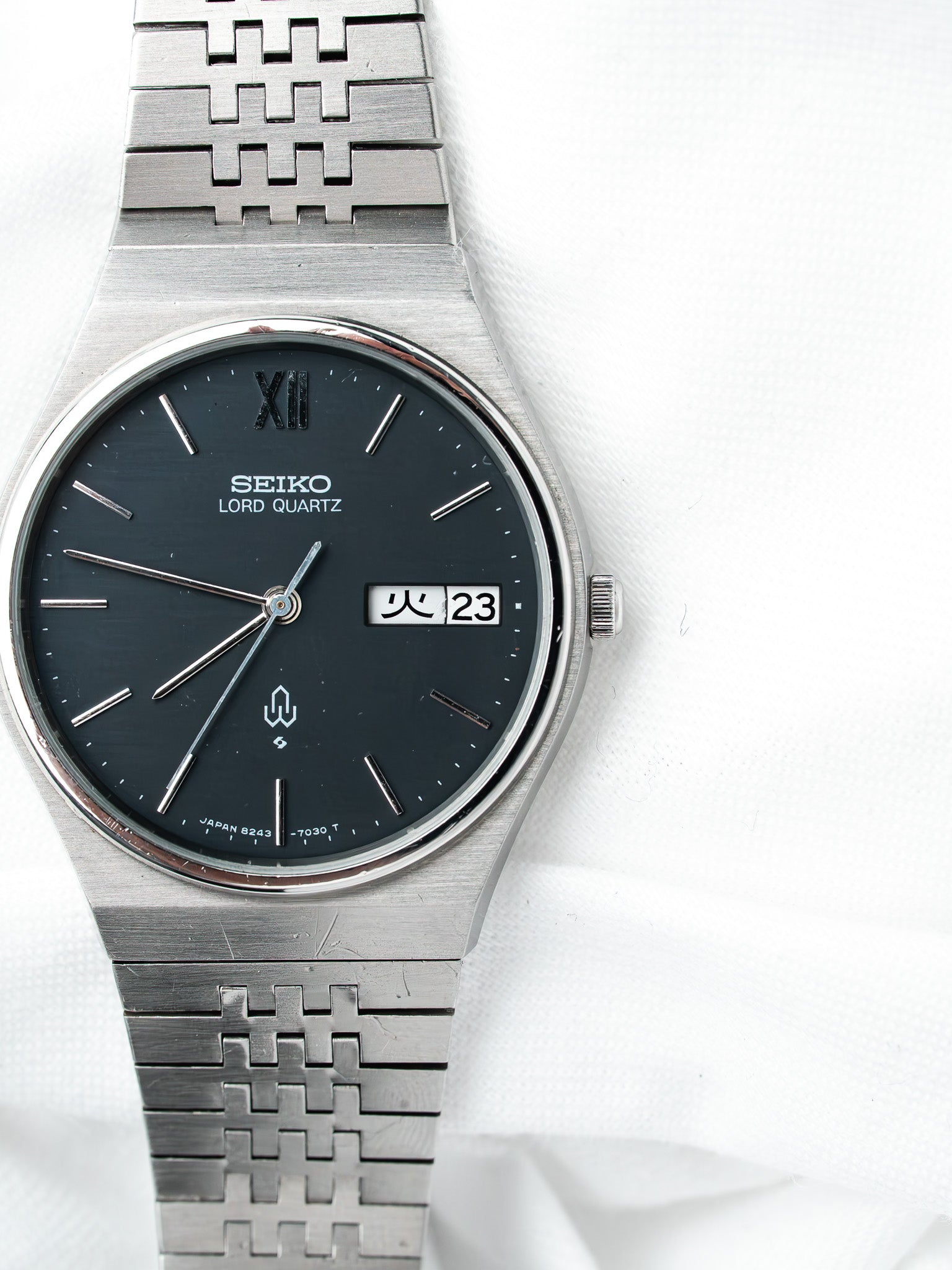 Seiko Lord Quartz vintage watch with black dial, steel bracelet, day-date display