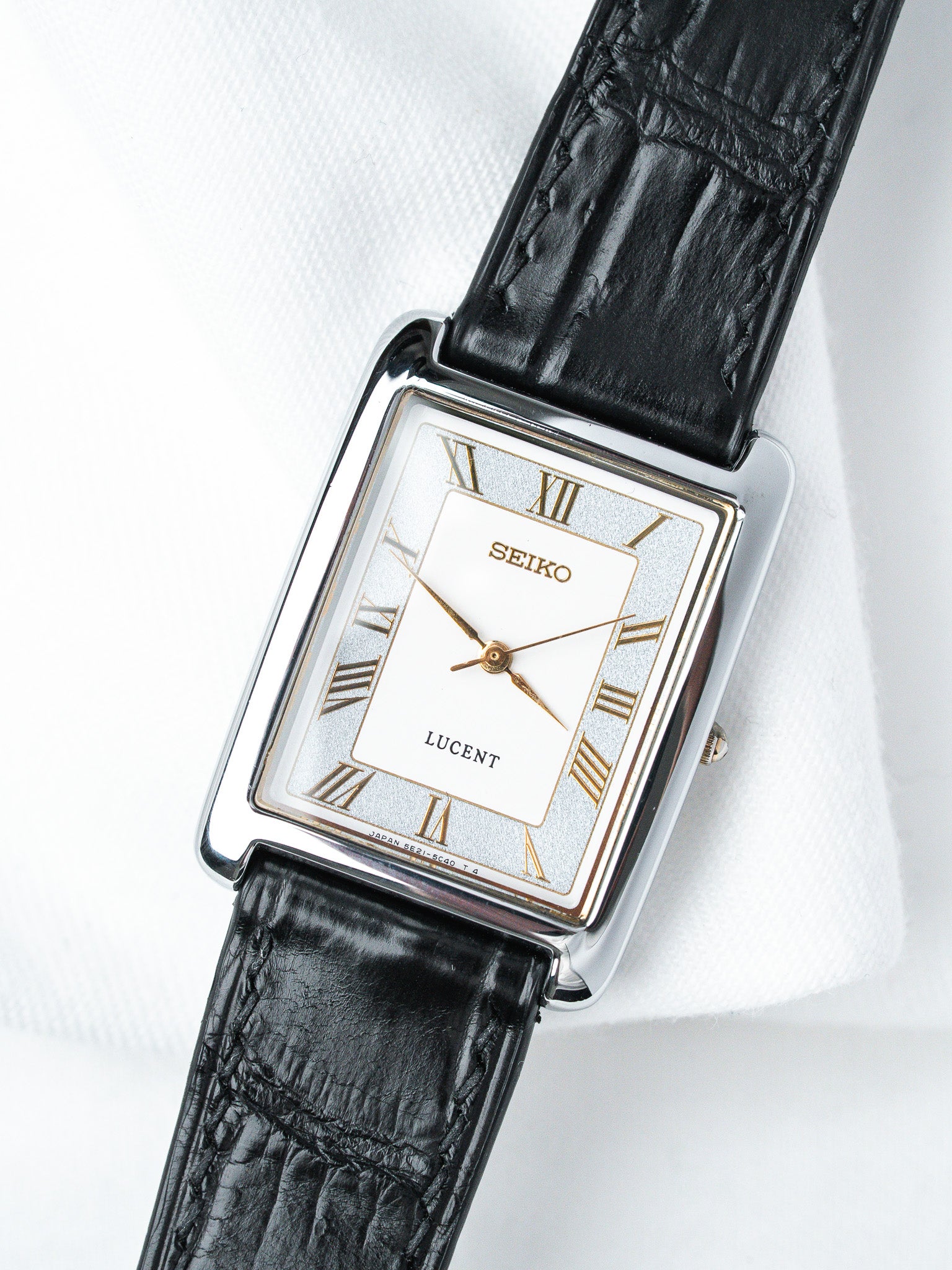 Seiko Lucent vintage watch with rectangular case, white dial, Roman numerals, black leather strap