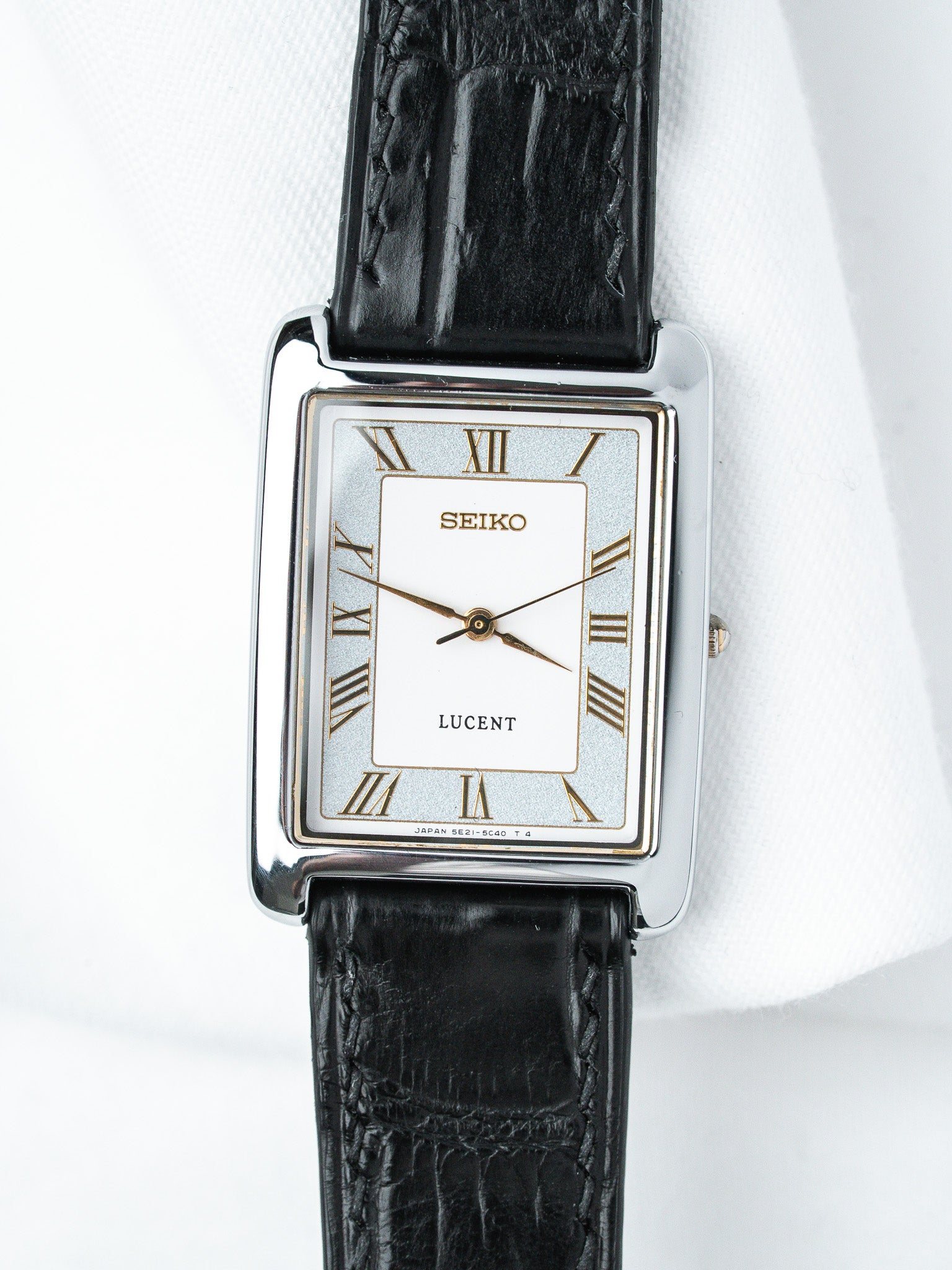 Seiko Lucent vintage watch with rectangular case, white dial, Roman numerals, black leather strap