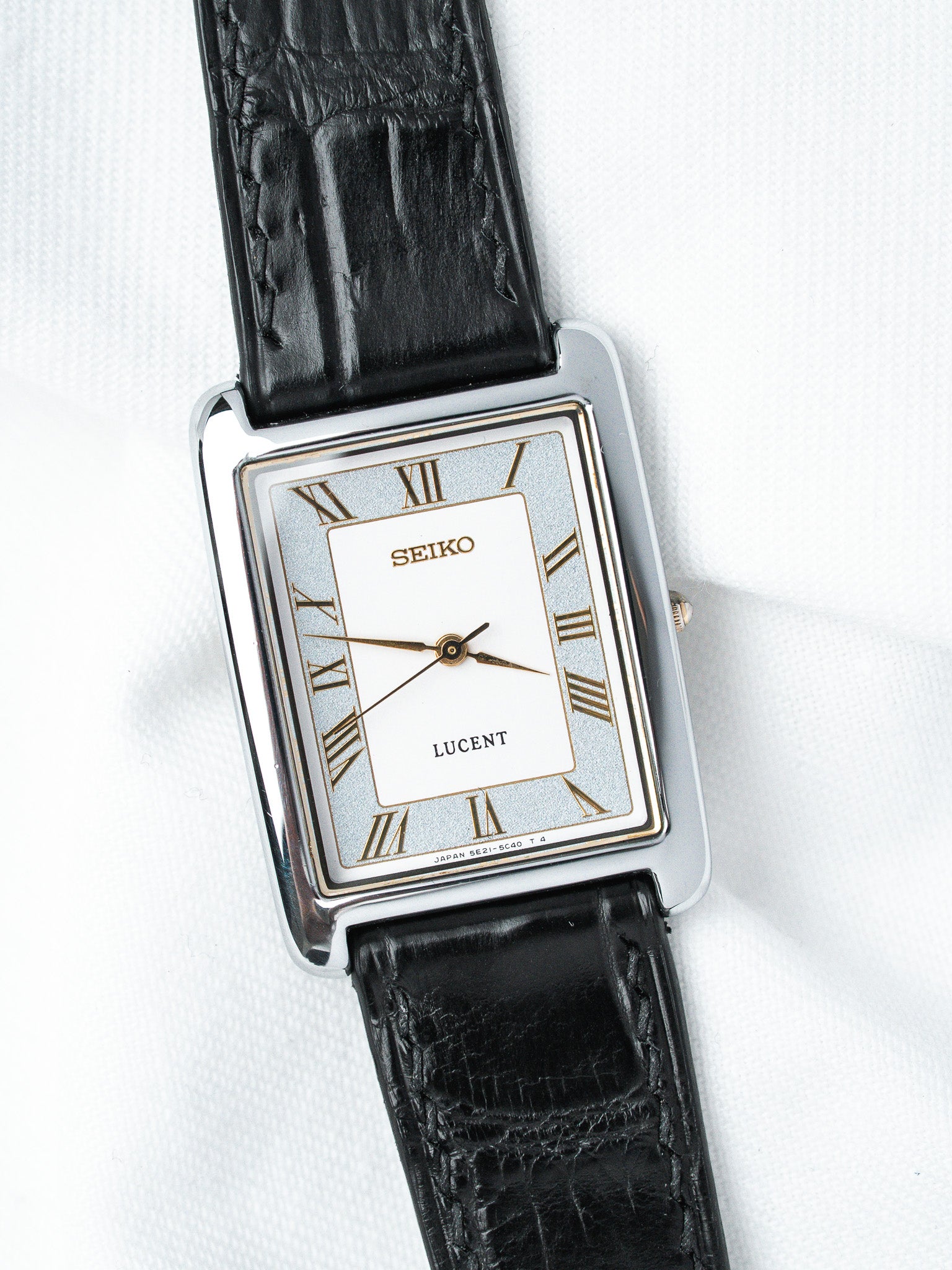 Seiko Lucent vintage watch with rectangular case, white dial, Roman numerals, black leather strap