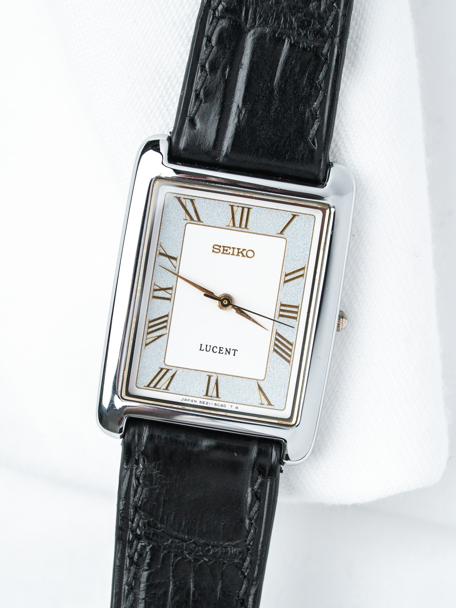 Seiko Lucent vintage watch with rectangular case, white dial, Roman numerals, black leather strap