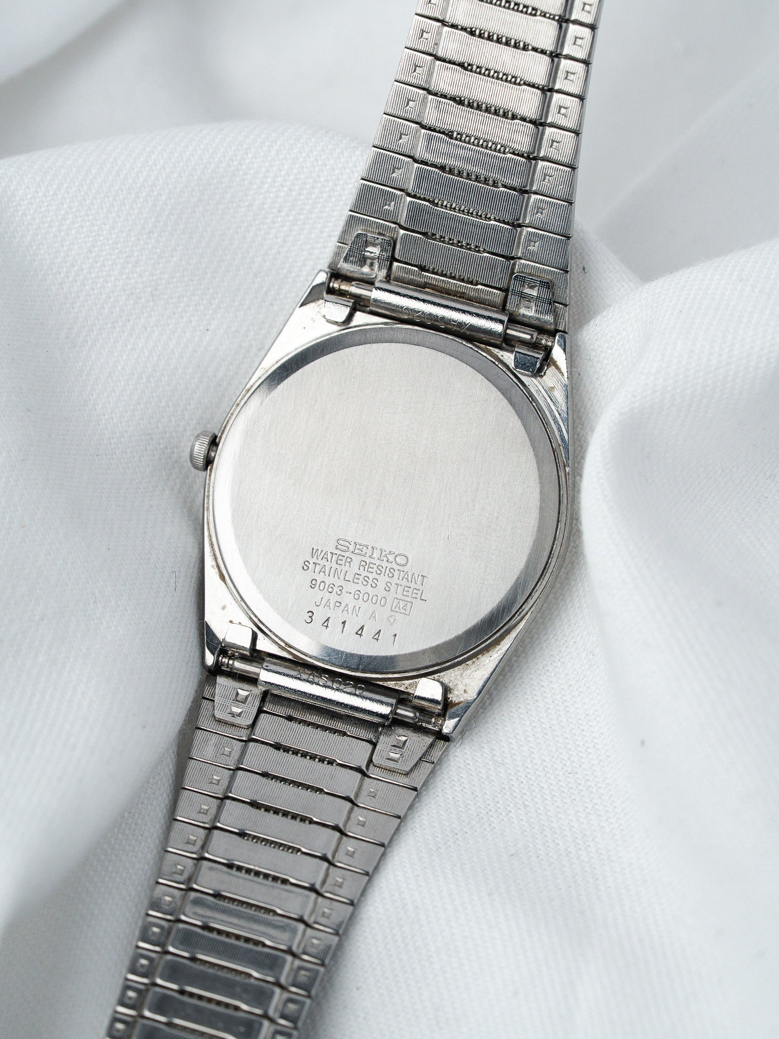 Seiko vintage watch back stainless steel water resistant on white fabric