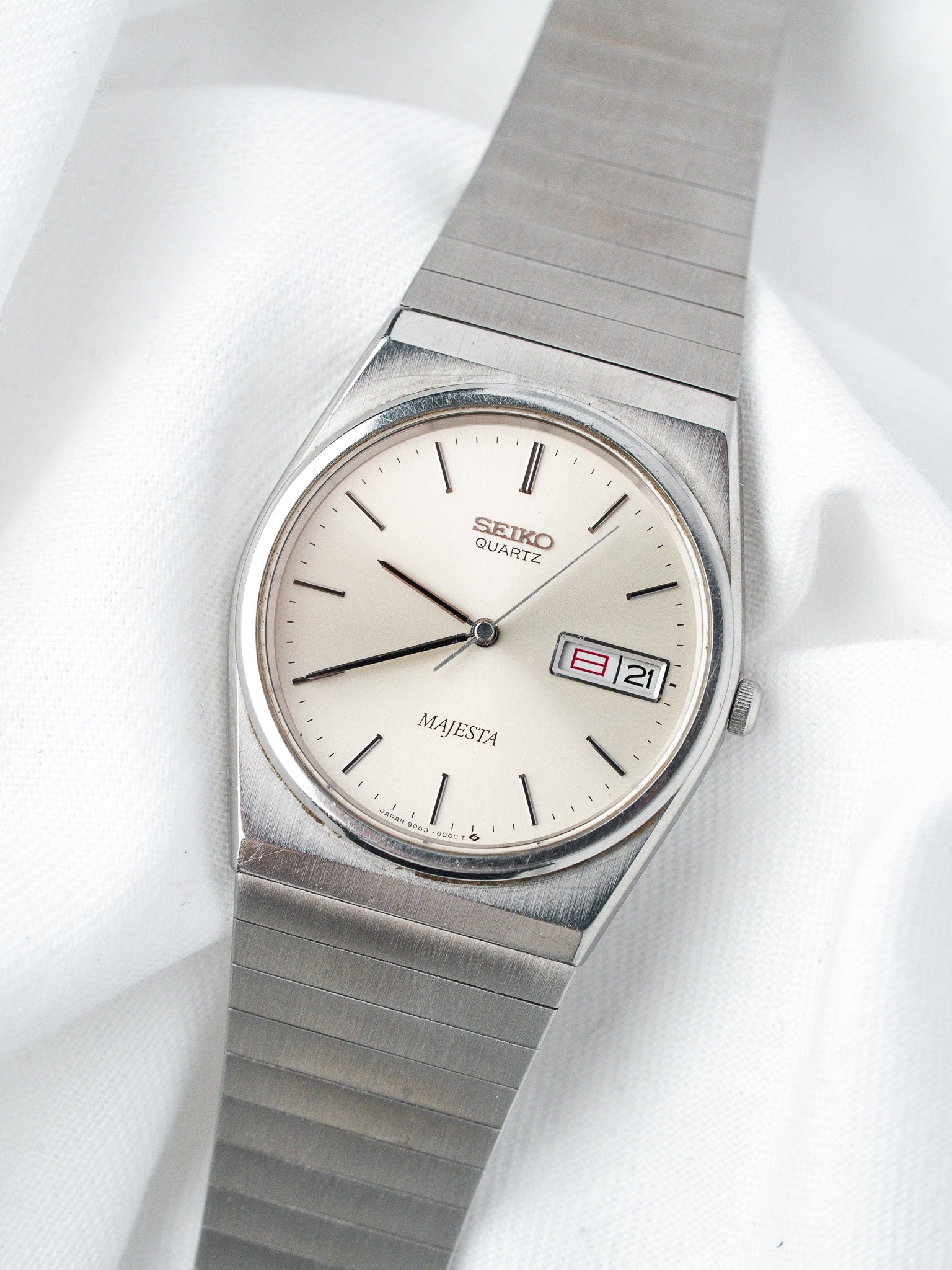 Seiko Majesta vintage quartz watch with silver dial and date, steel bracelet on white fabric