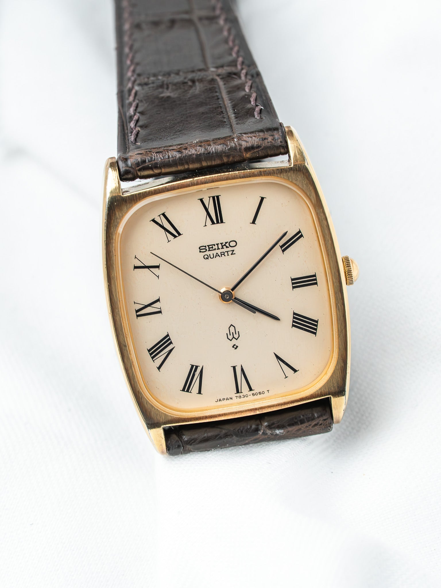 Seiko Quartz vintage watch with gold case, cream dial, Roman numerals, brown leather strap