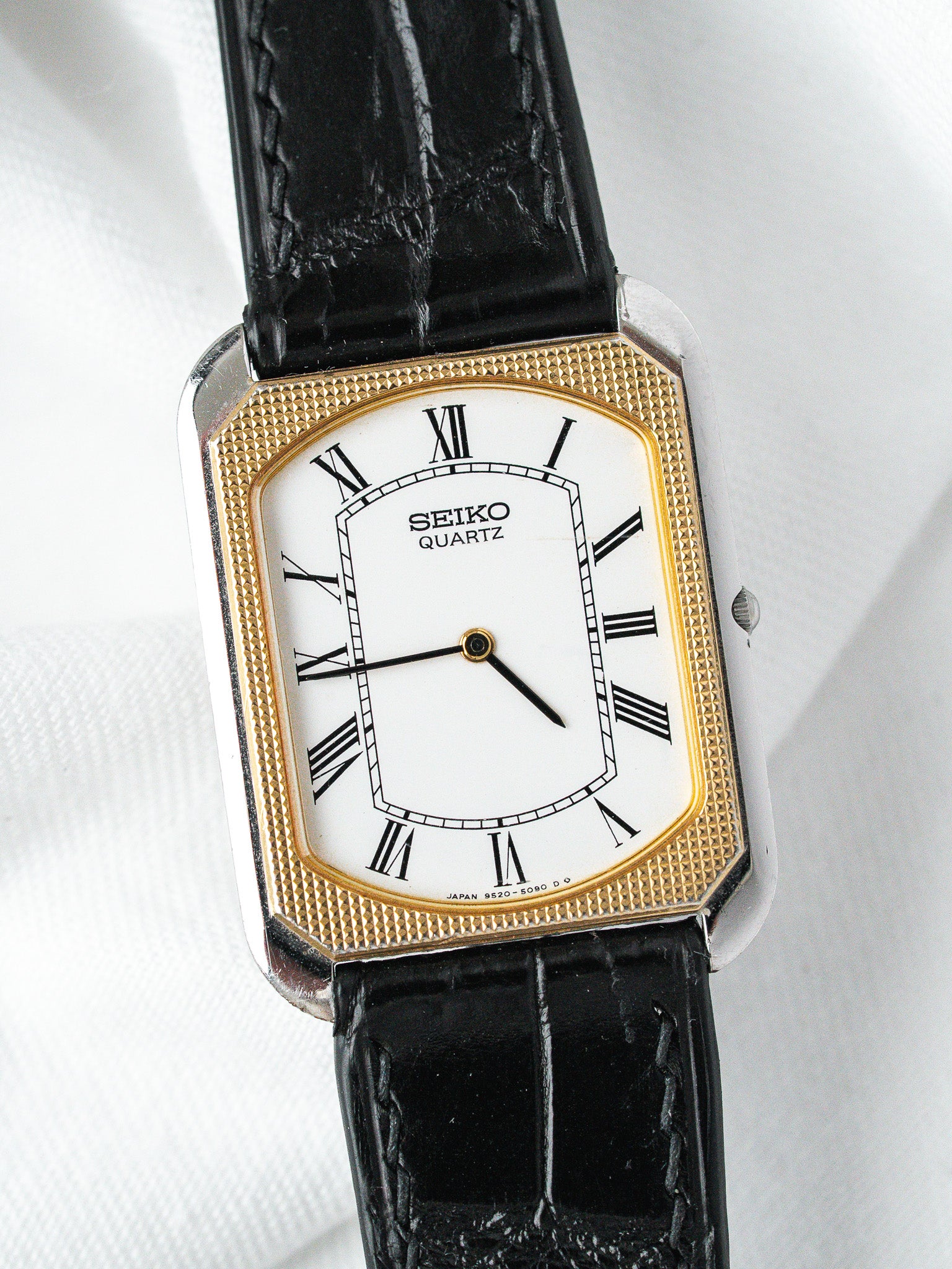 Seiko Quartz vintage watch with gold bezel, white dial, black leather strap