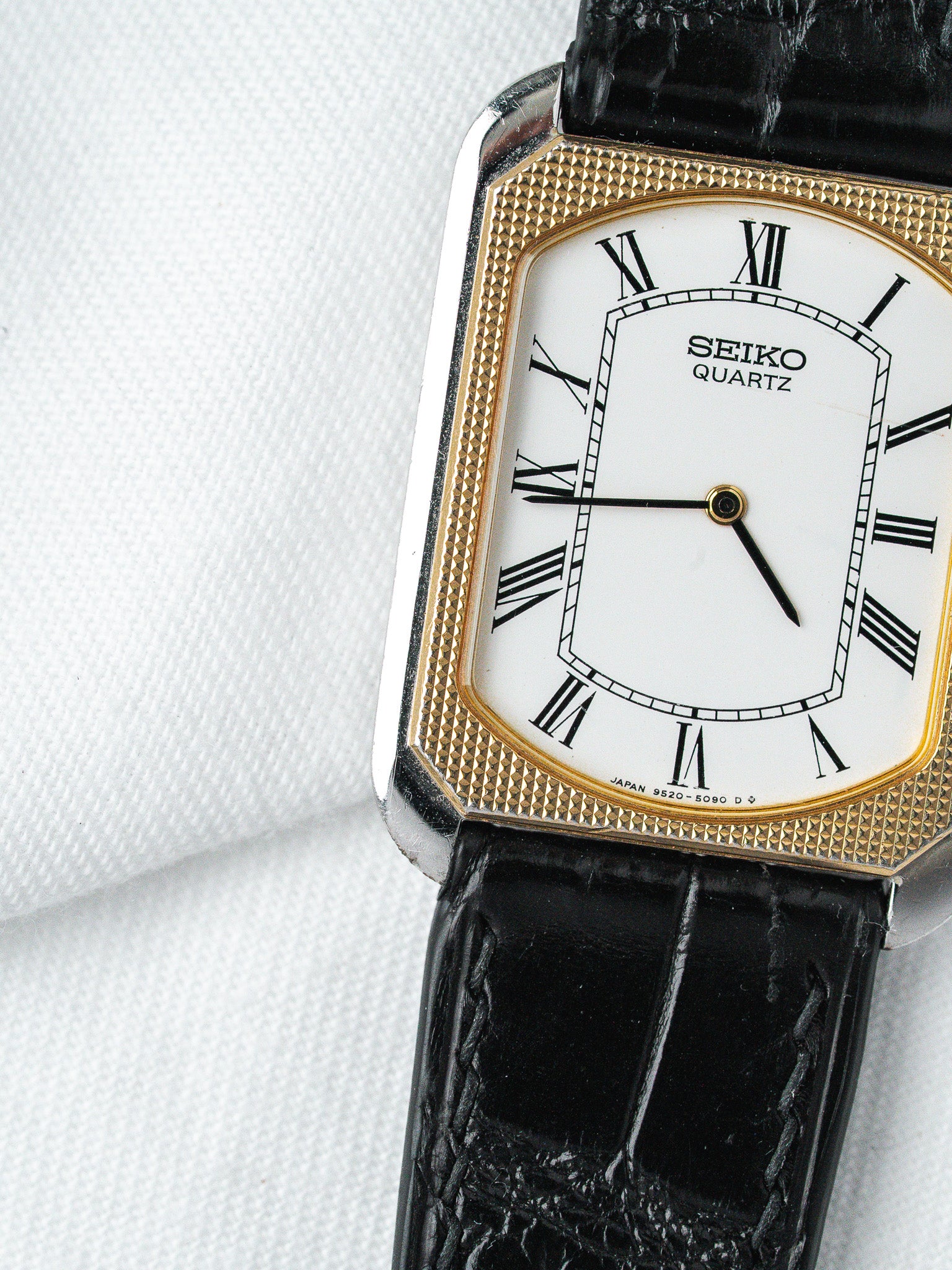 Seiko Quartz vintage watch with white dial, Roman numerals, gold bezel, black leather strap