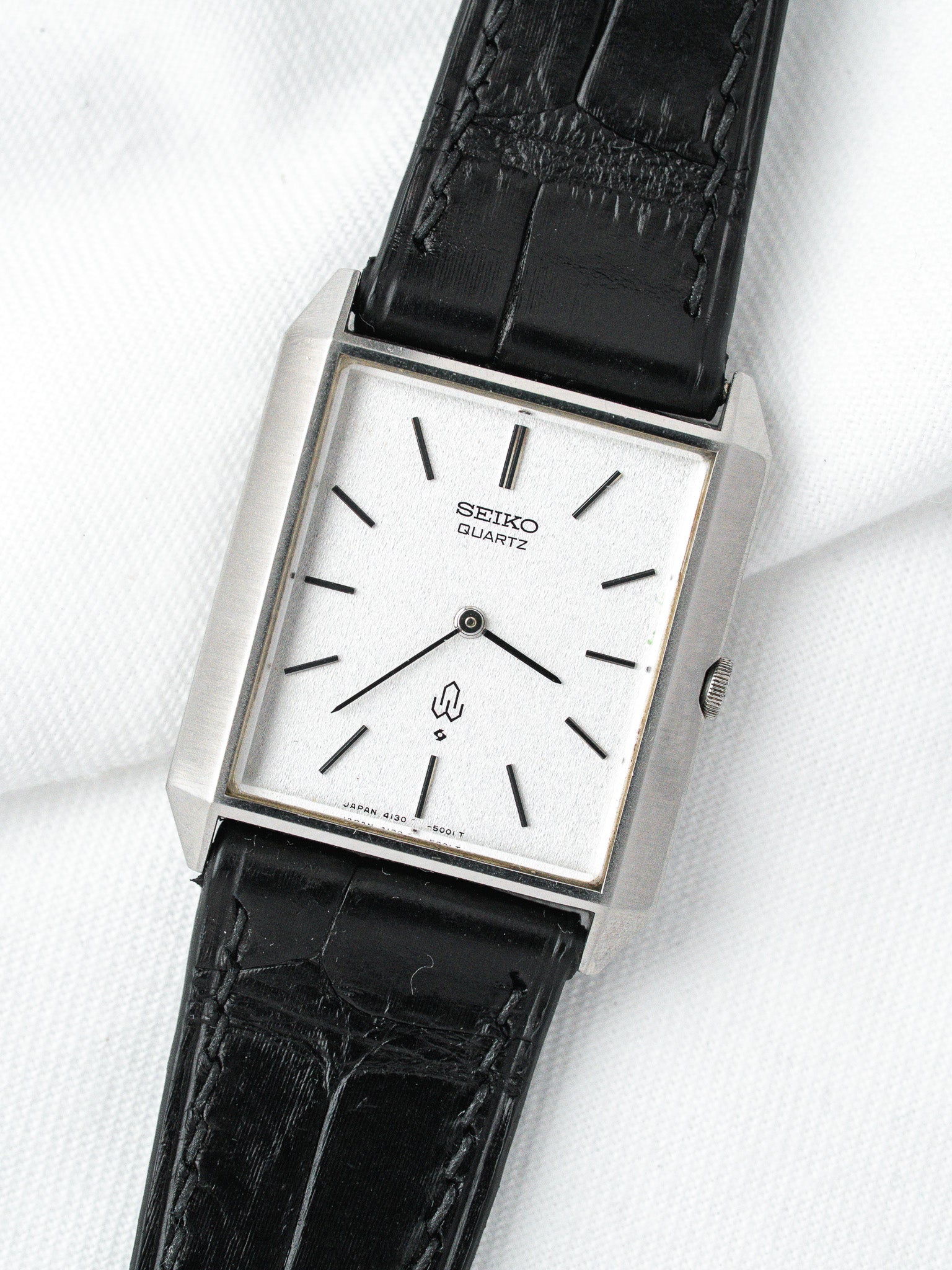 Seiko Quartz vintage watch with silver case, white dial, black leather strap