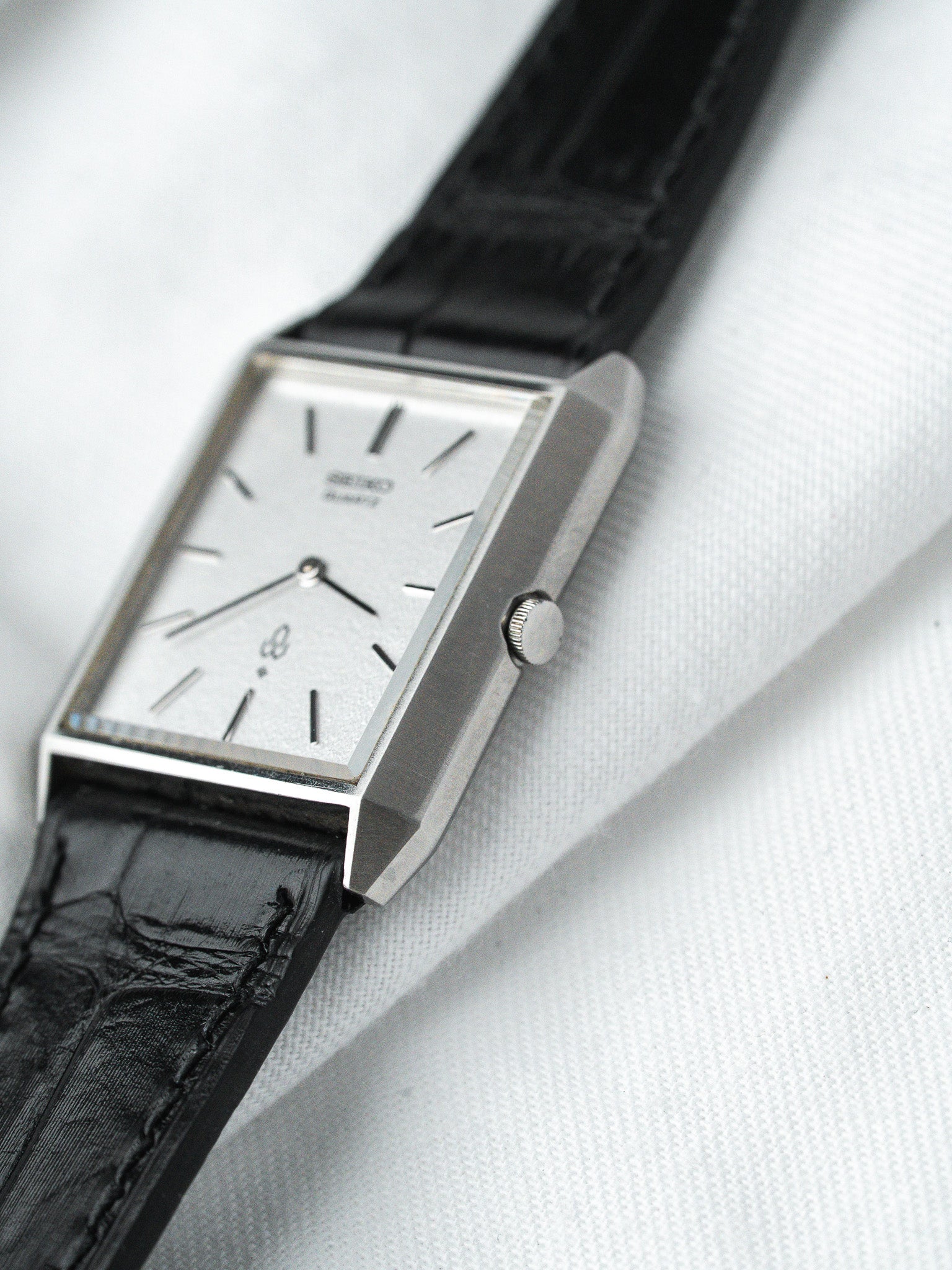 Seiko vintage watch with rectangular silver case and black leather strap