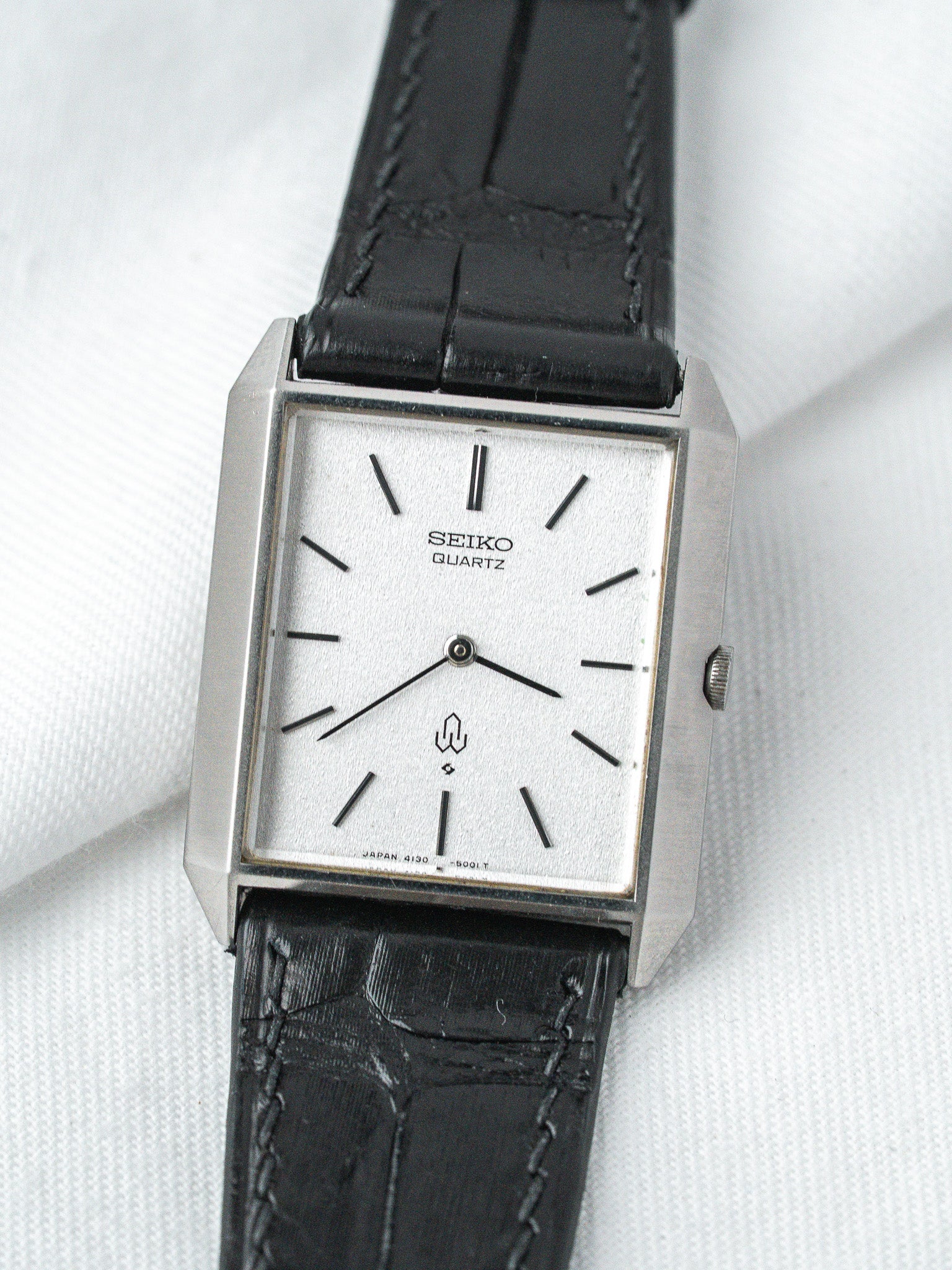 Seiko Quartz vintage watch with silver dial, black leather strap, rectangular case