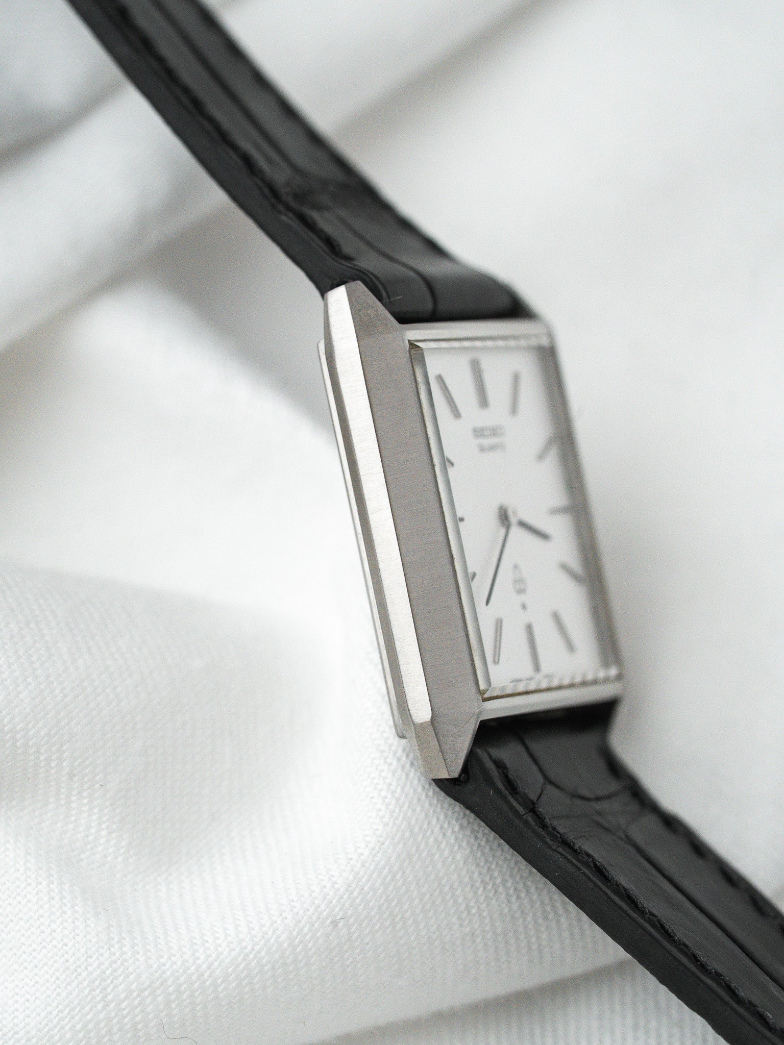 Seiko vintage watch with rectangular silver case and black leather strap