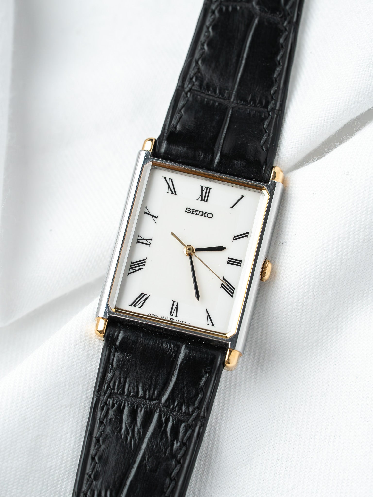 Seiko vintage watch with white dial, Roman numerals, black leather strap