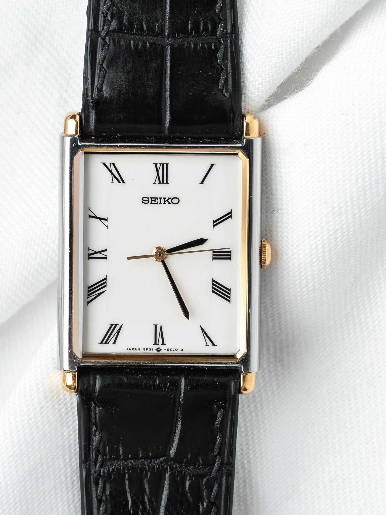 Seiko vintage watch with white dial, Roman numerals, black leather strap