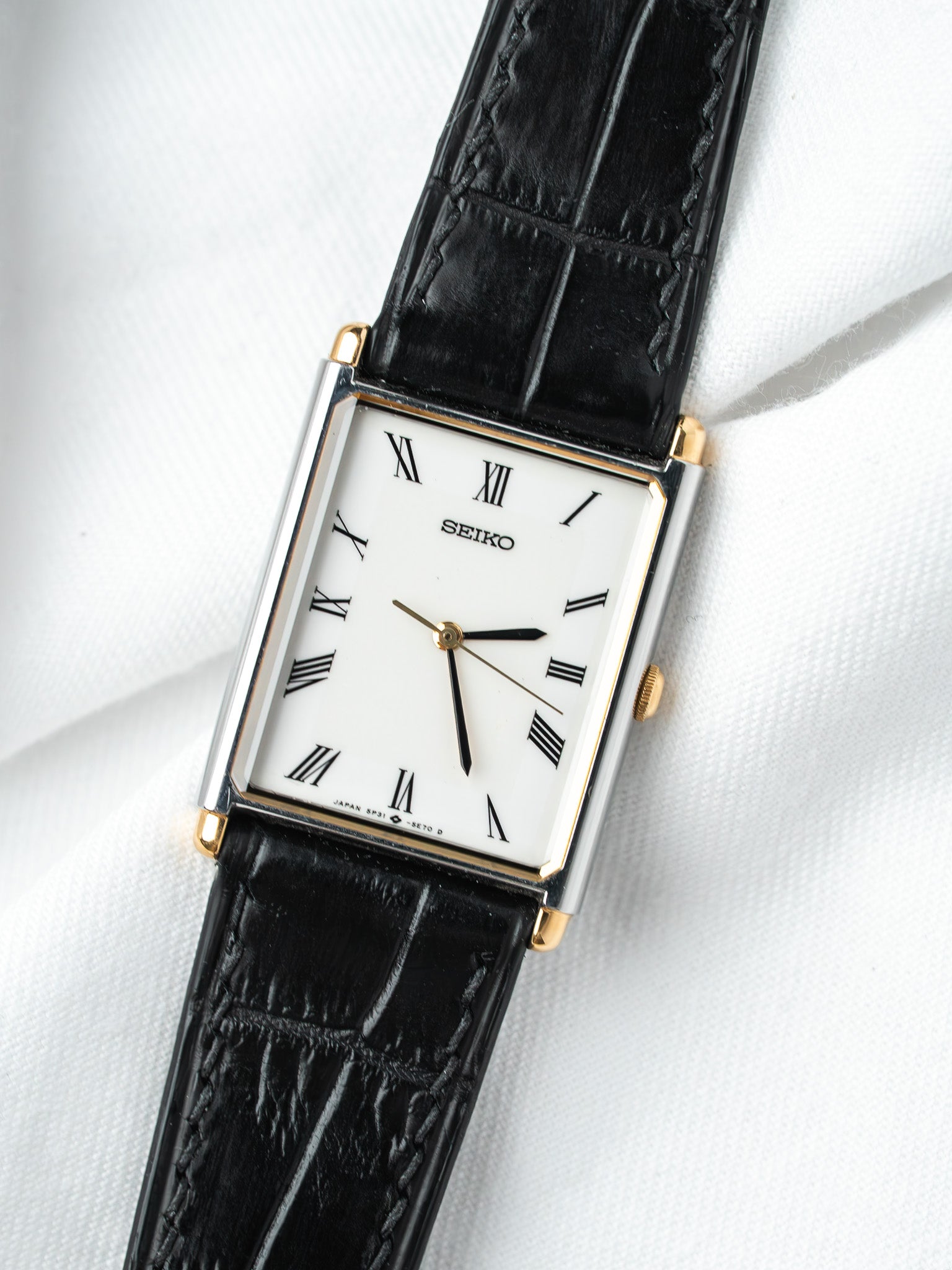Seiko vintage watch with white dial, Roman numerals, black leather strap