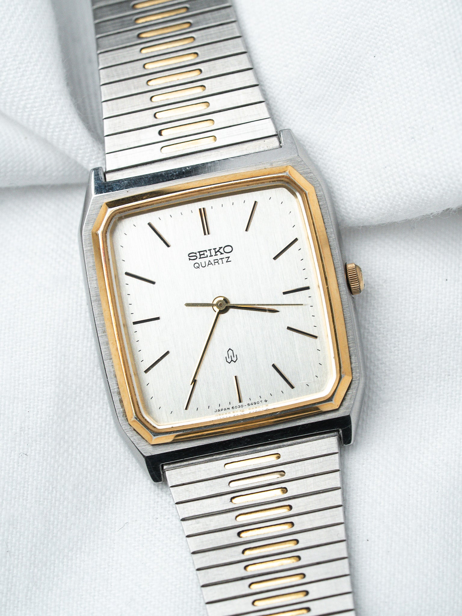 Seiko Quartz vintage watch with silver dial, gold accents, and two-tone metal bracelet
