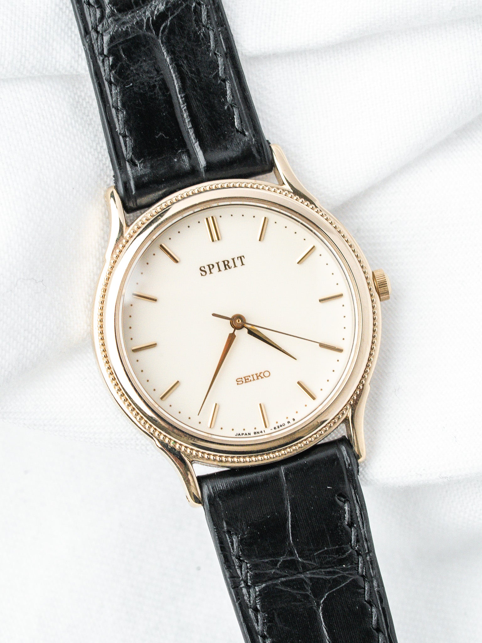 Seiko Spirit vintage watch with gold case, cream dial, black alligator strap