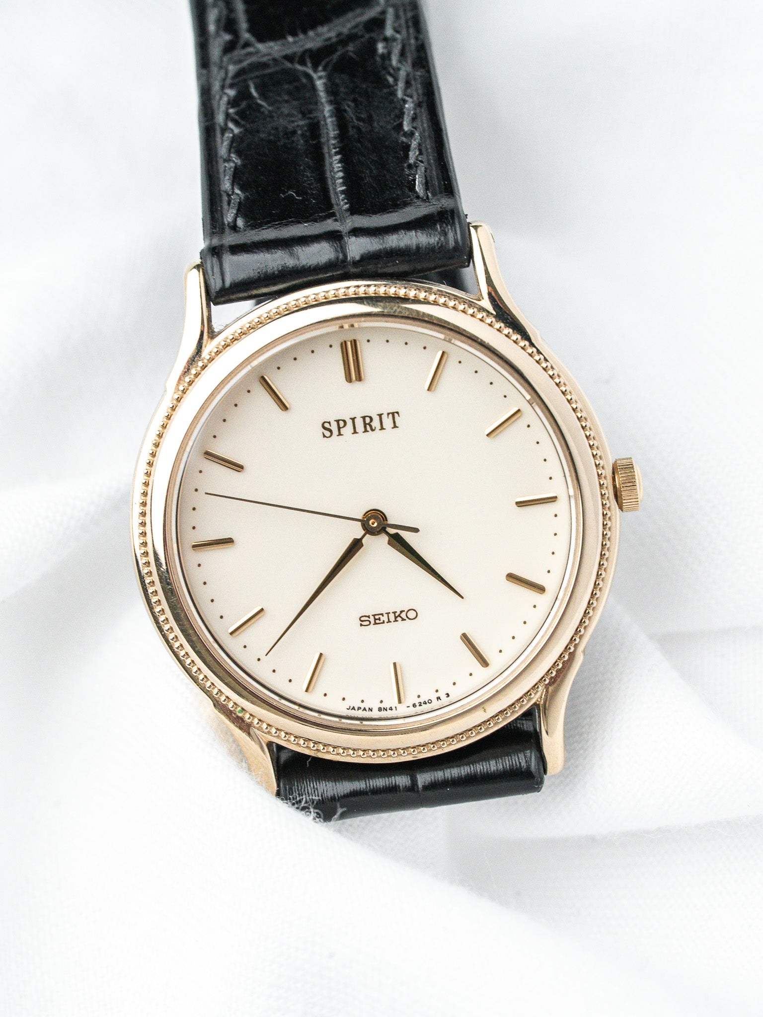 Seiko Spirit vintage watch with gold case, cream dial, black alligator strap