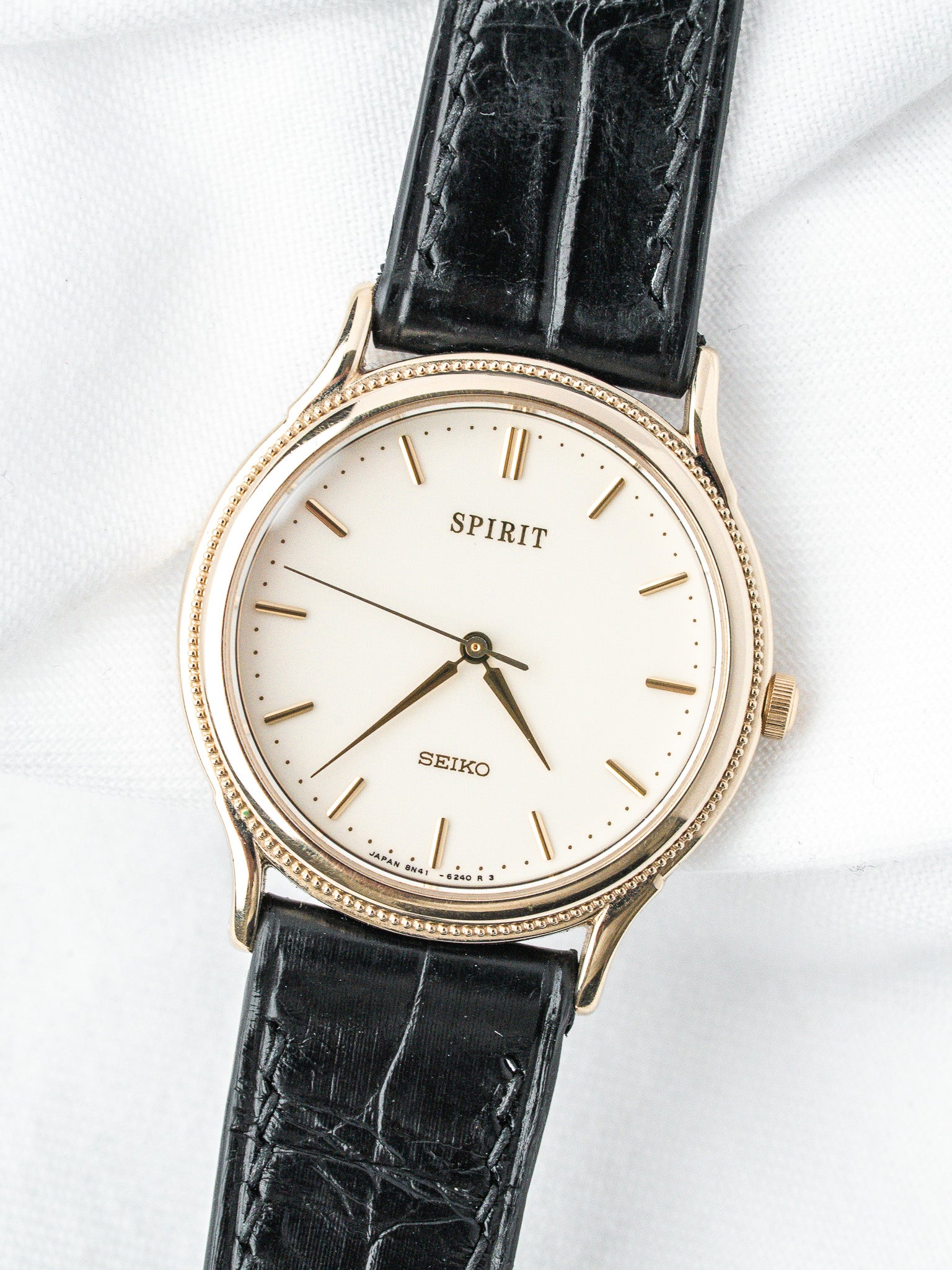 Seiko Spirit vintage watch with gold case, white dial, black leather strap