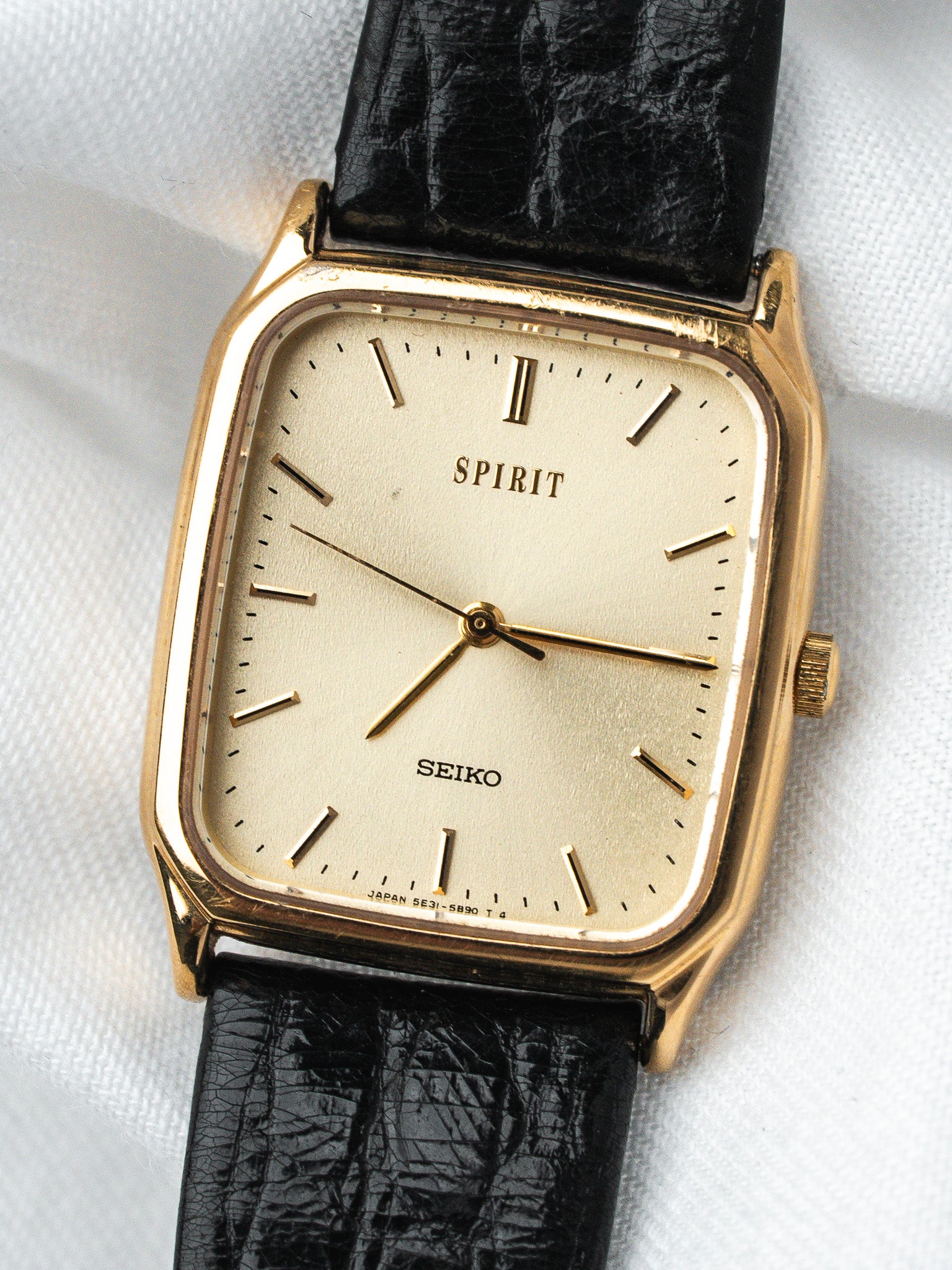 Seiko Spirit vintage watch with gold case, cream dial, black leather strap