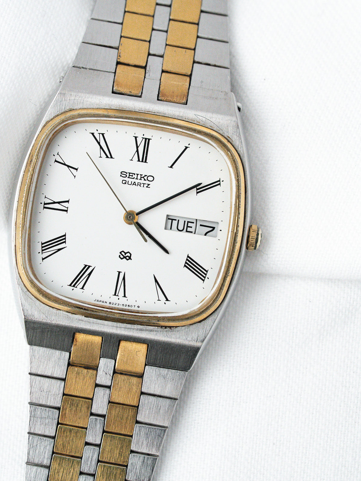 Seiko Quartz vintage watch with white dial, Roman numerals, two-tone bracelet