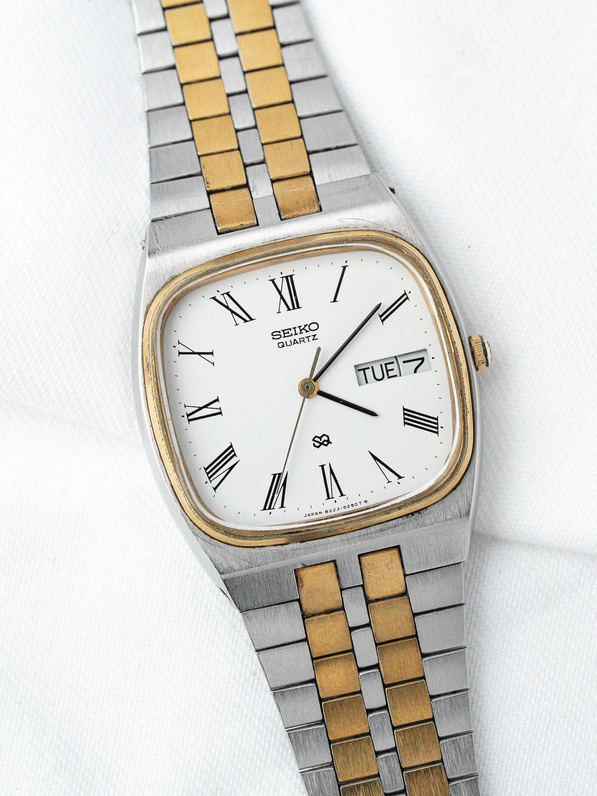 Seiko Quartz vintage watch with white dial, Roman numerals, two-tone steel and gold bracelet