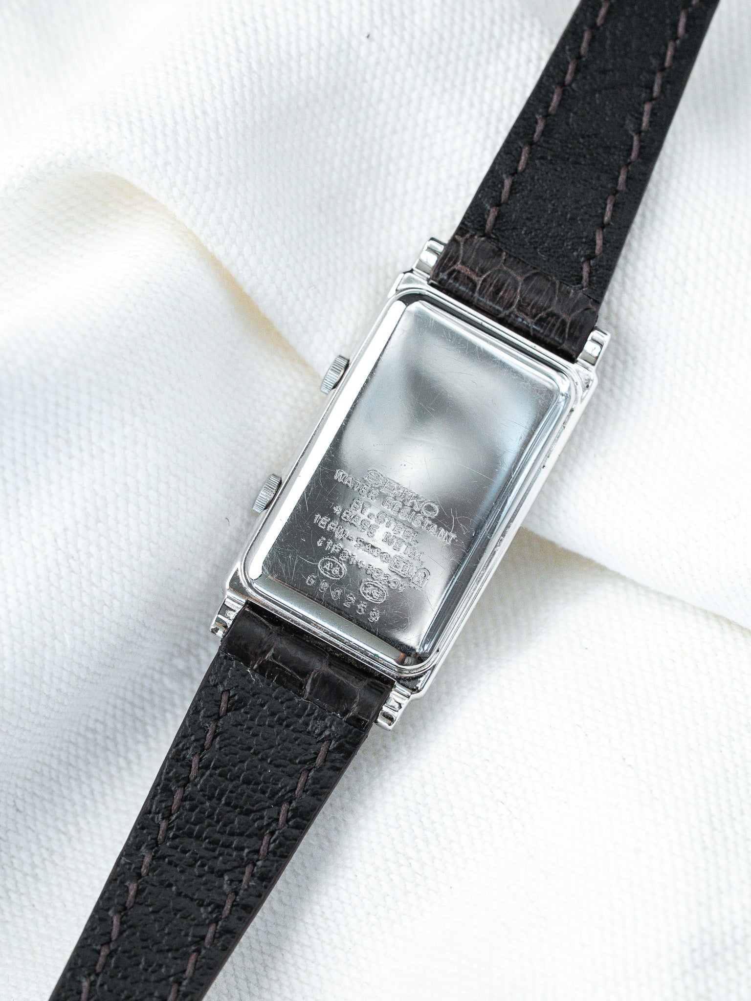 Seiko vintage watch with rectangular steel case and black leather strap