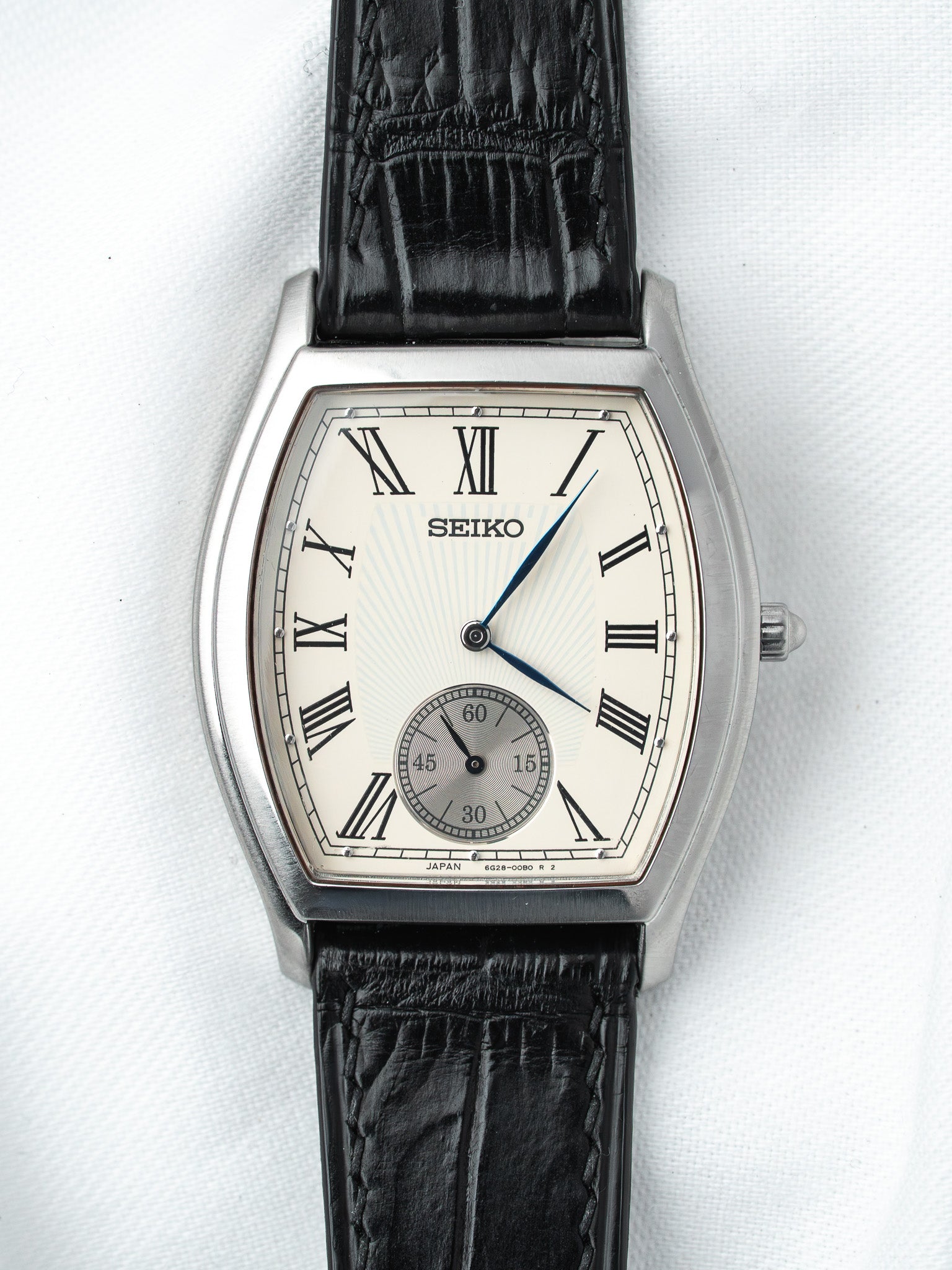 Seiko vintage watch with silver case, cream dial, Roman numerals, black leather strap