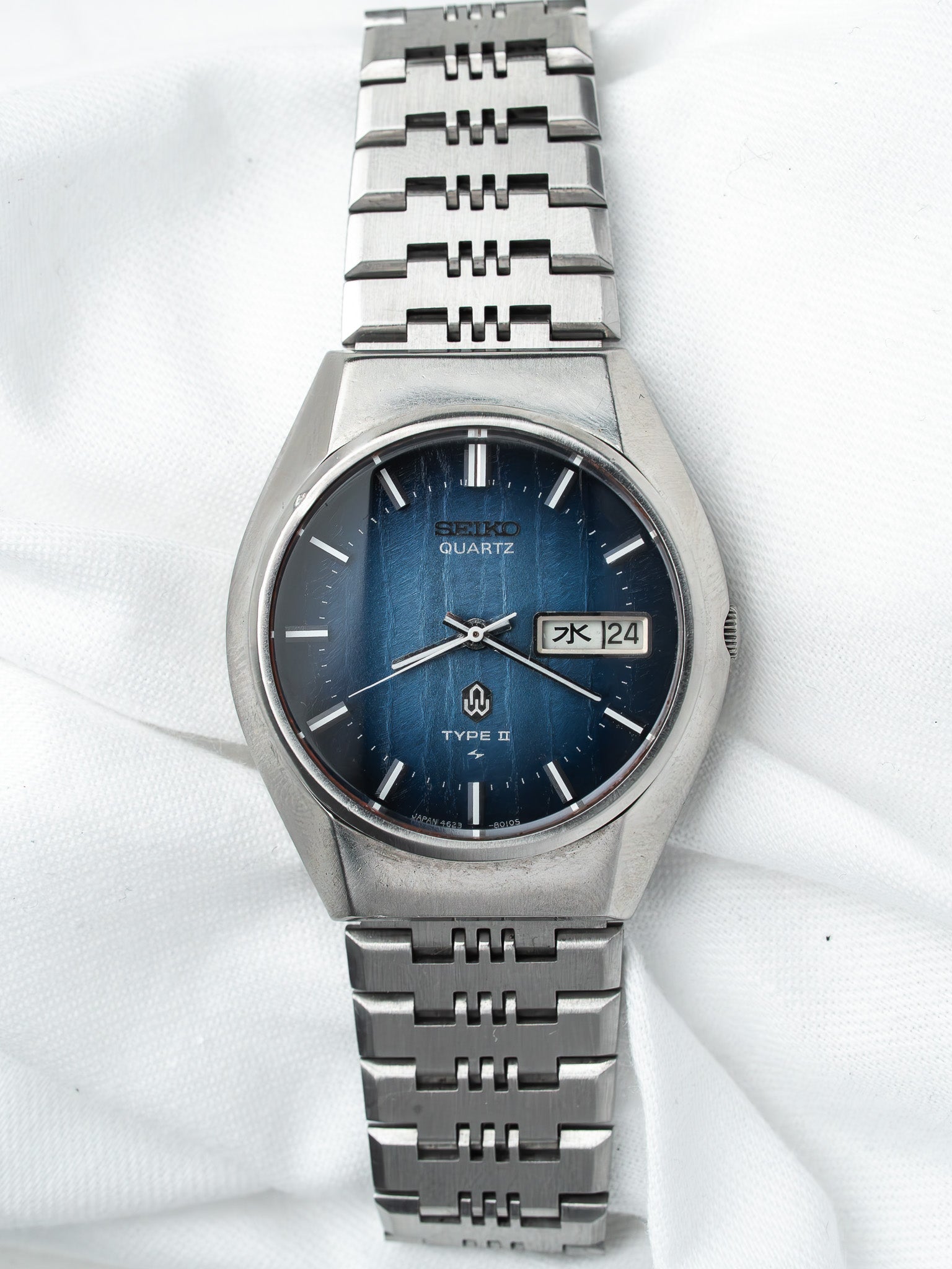 Seiko Quartz Type II vintage watch with blue dial and steel bracelet on white fabric