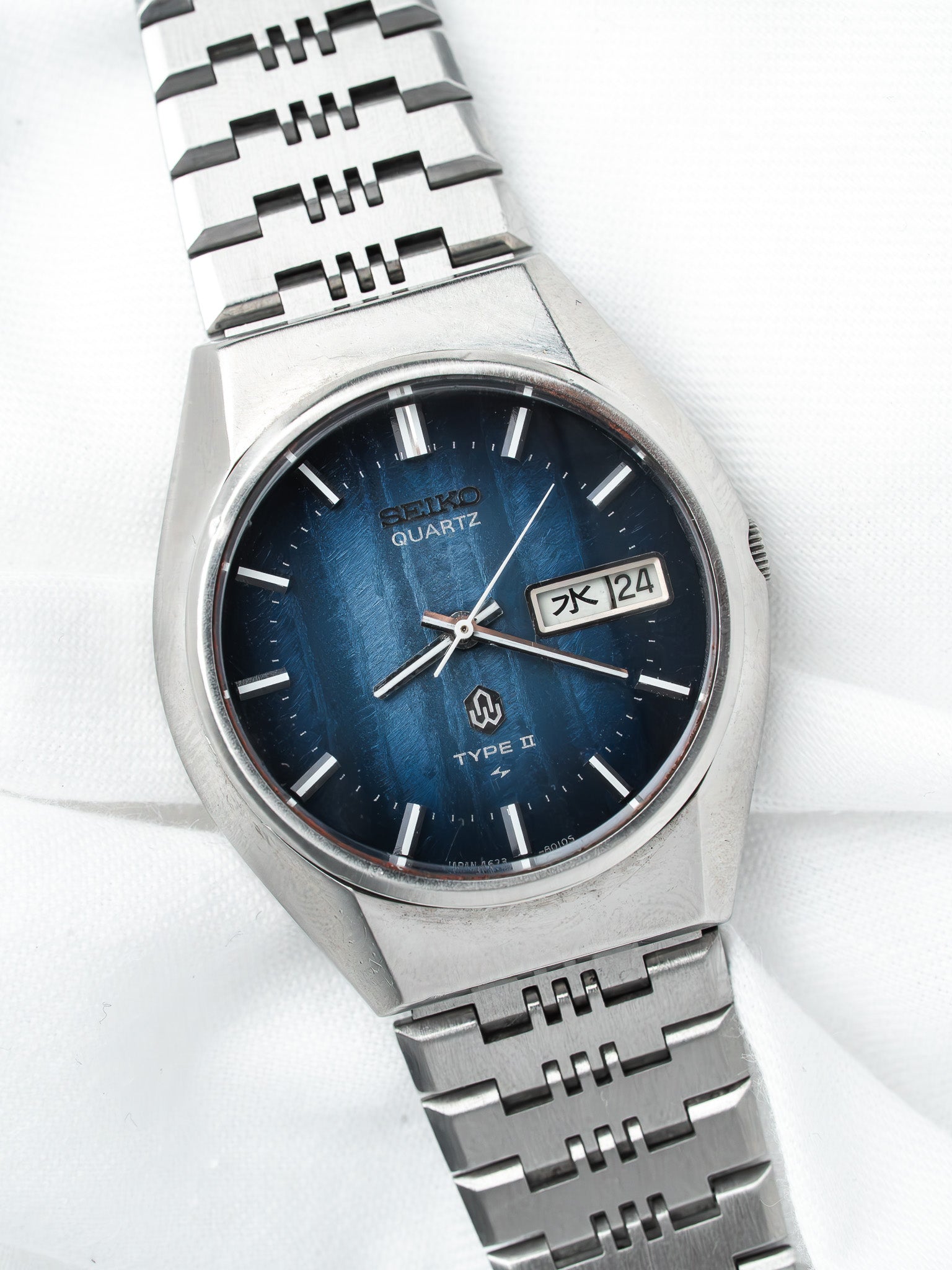 Seiko Quartz Type II vintage watch with blue dial and steel bracelet on white background