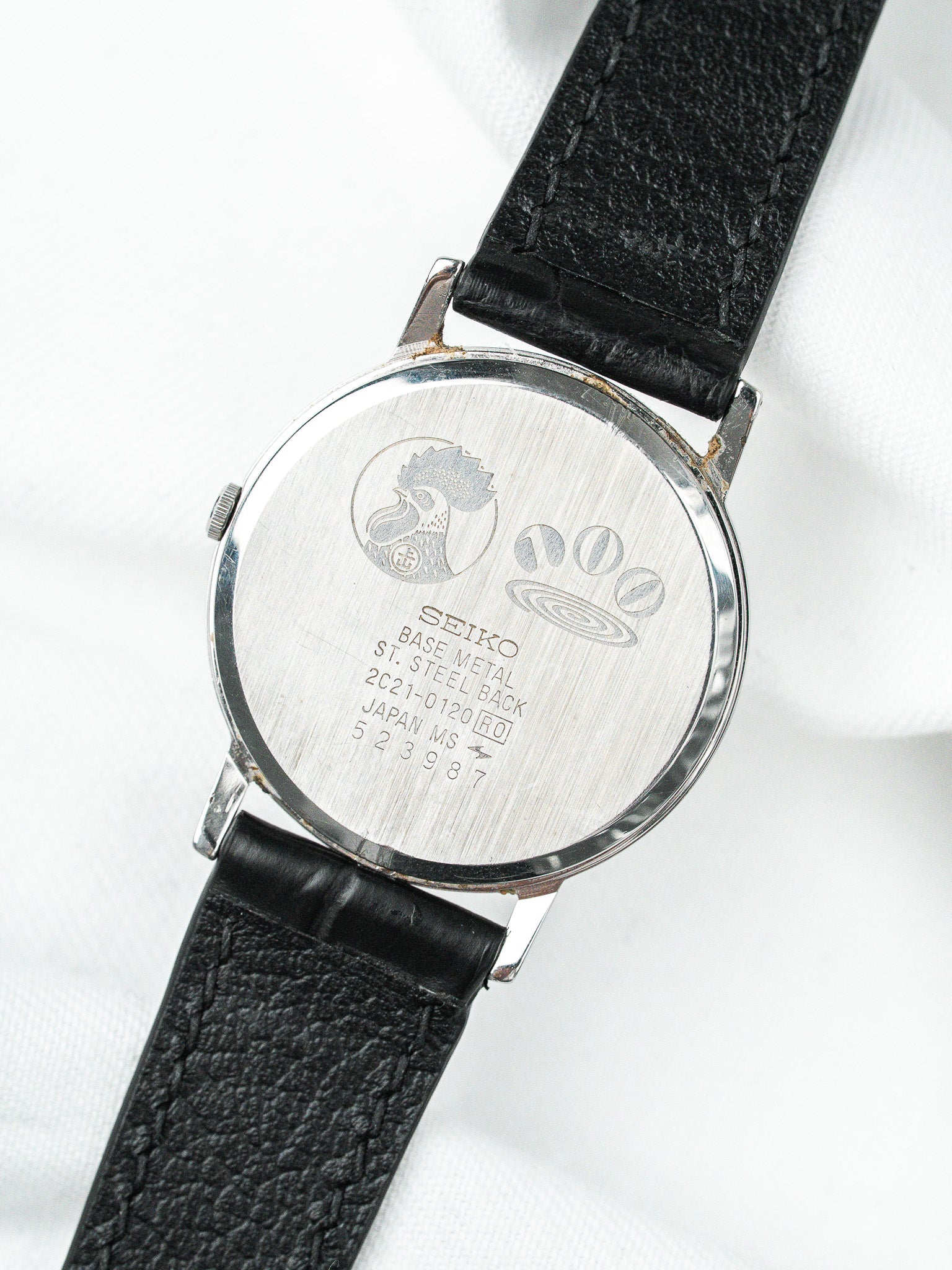 Seiko vintage watch back with engraved rooster logo, steel case, black leather strap