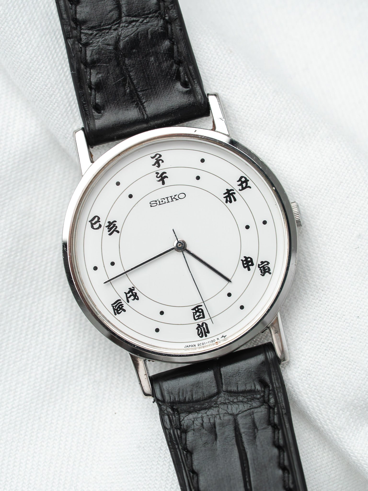 Seiko vintage watch with white dial, Japanese characters, black leather strap