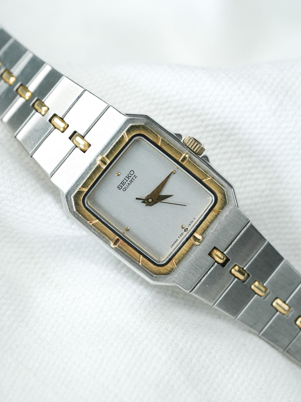Seiko Quartz vintage watch with silver dial, gold accents, and two-tone bracelet