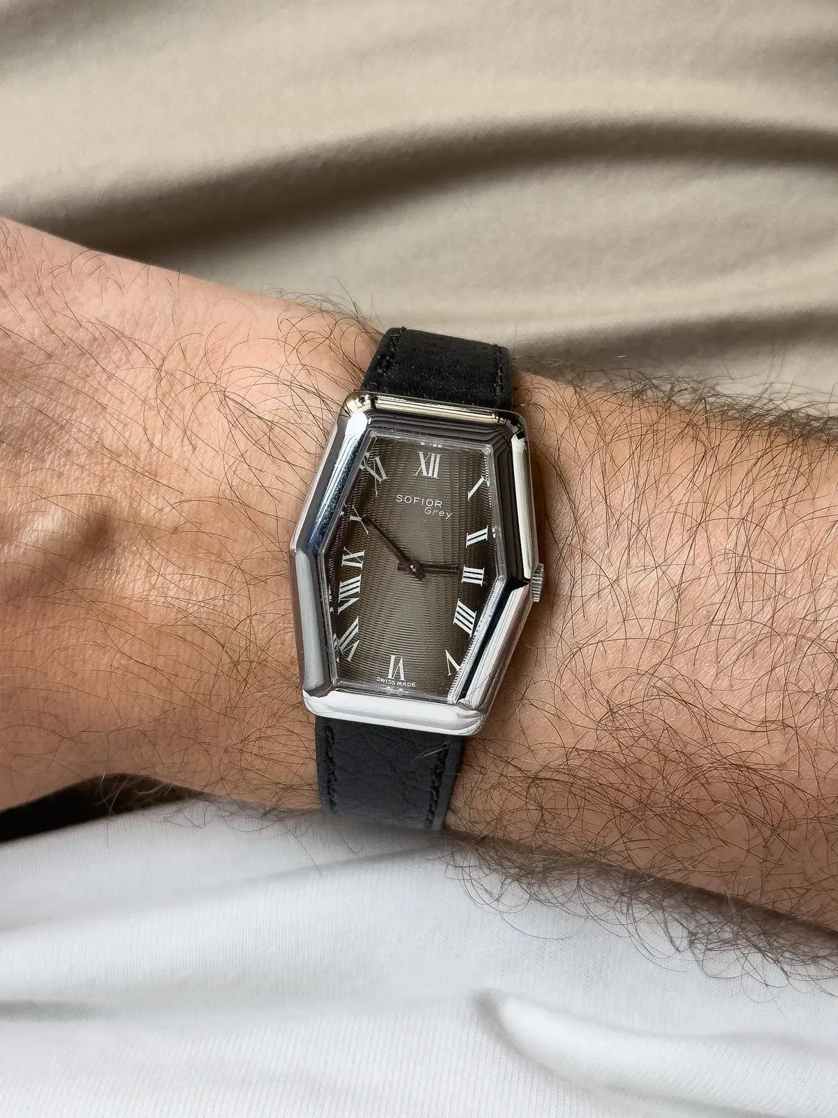 Sofior Grey vintage watch with grey dial, Roman numerals, black leather strap on wrist