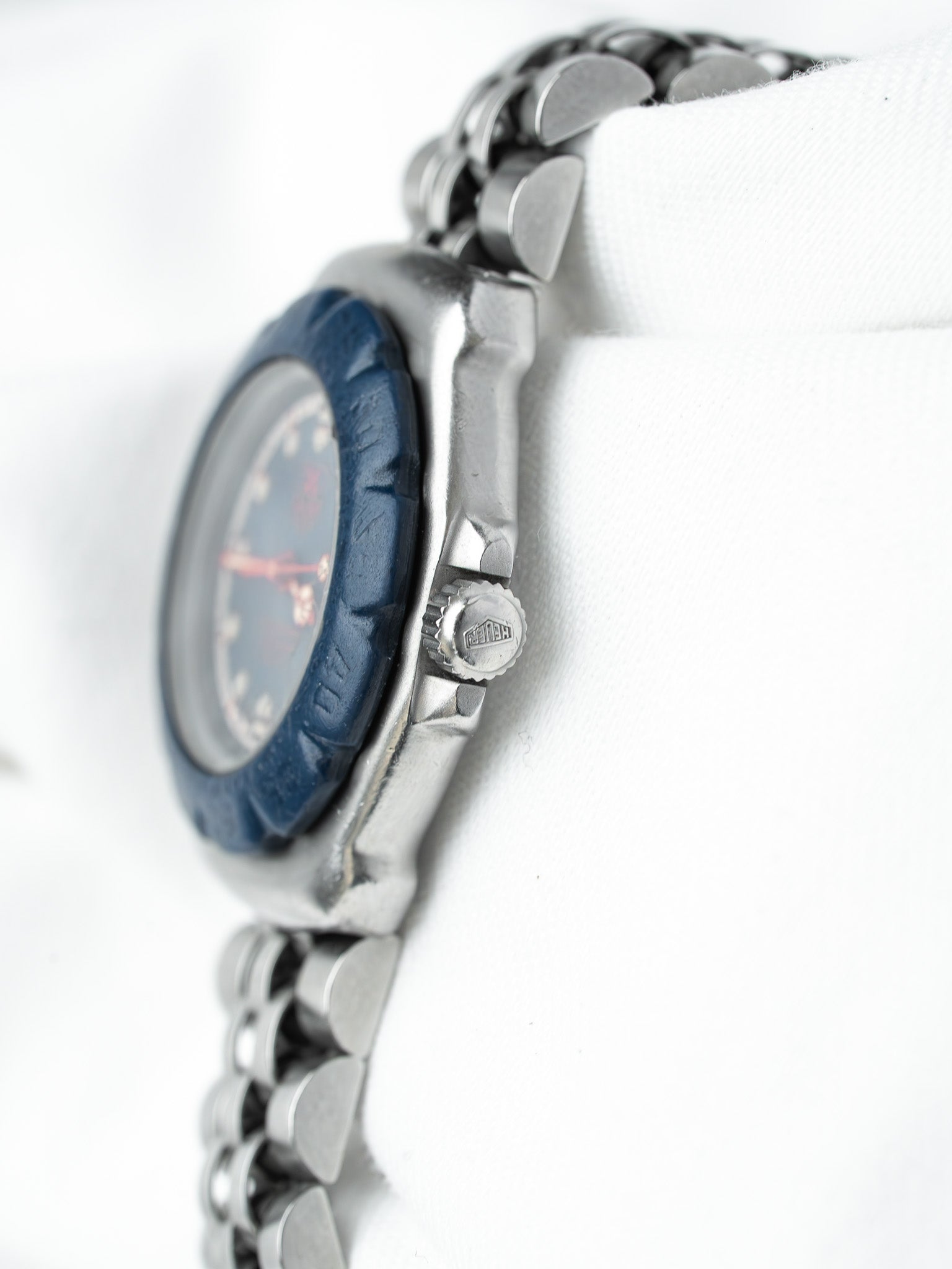 TAG Heuer vintage watch with blue bezel, steel bracelet, and textured dial