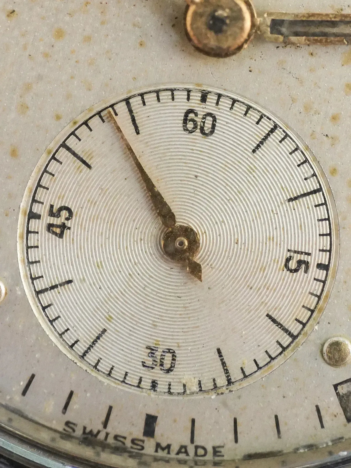 Vintage Swiss Made watch dial with guilloché pattern and black Arabic numerals