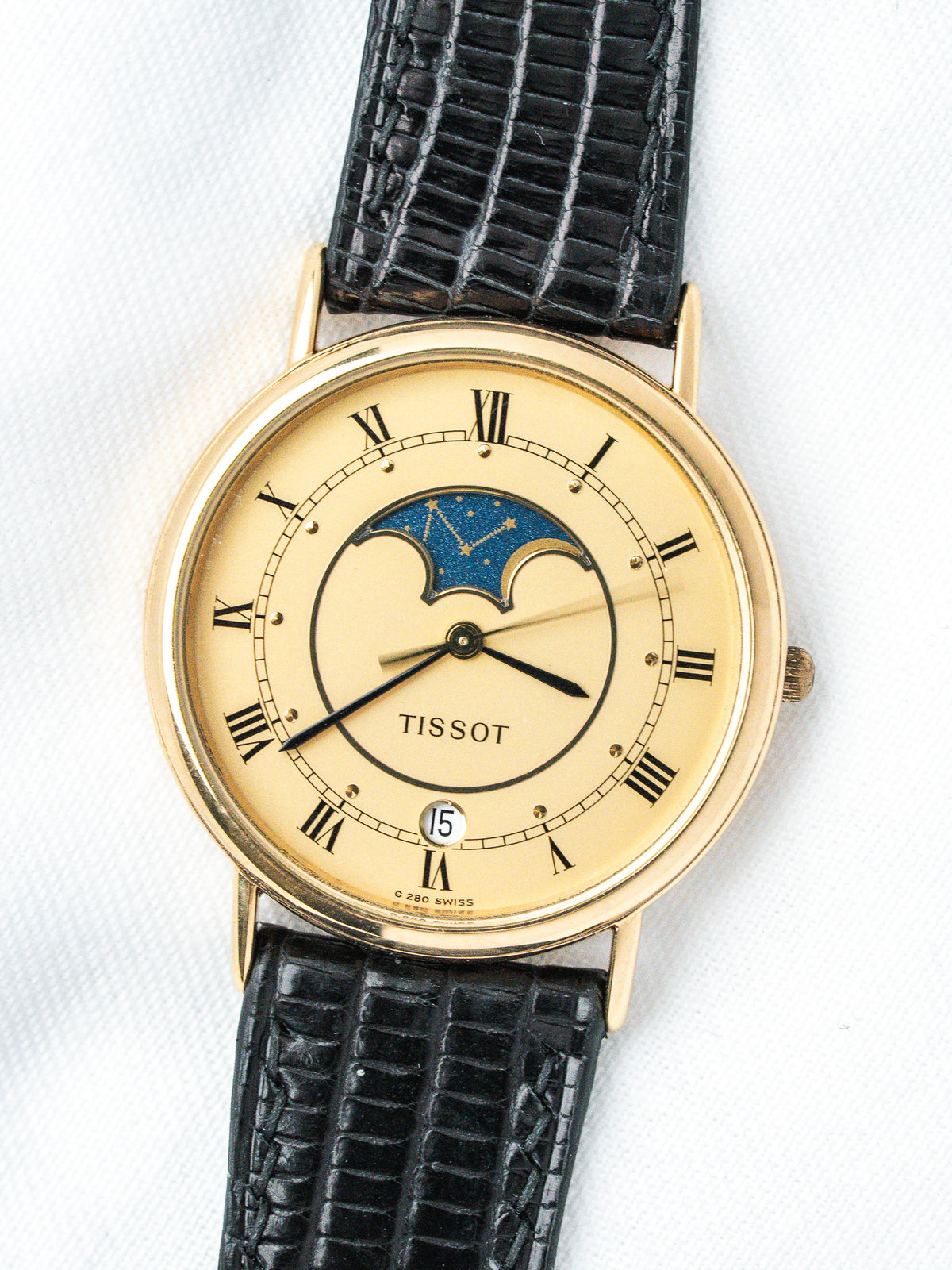 Tissot vintage watch with gold case, cream dial, moon phase, black alligator strap